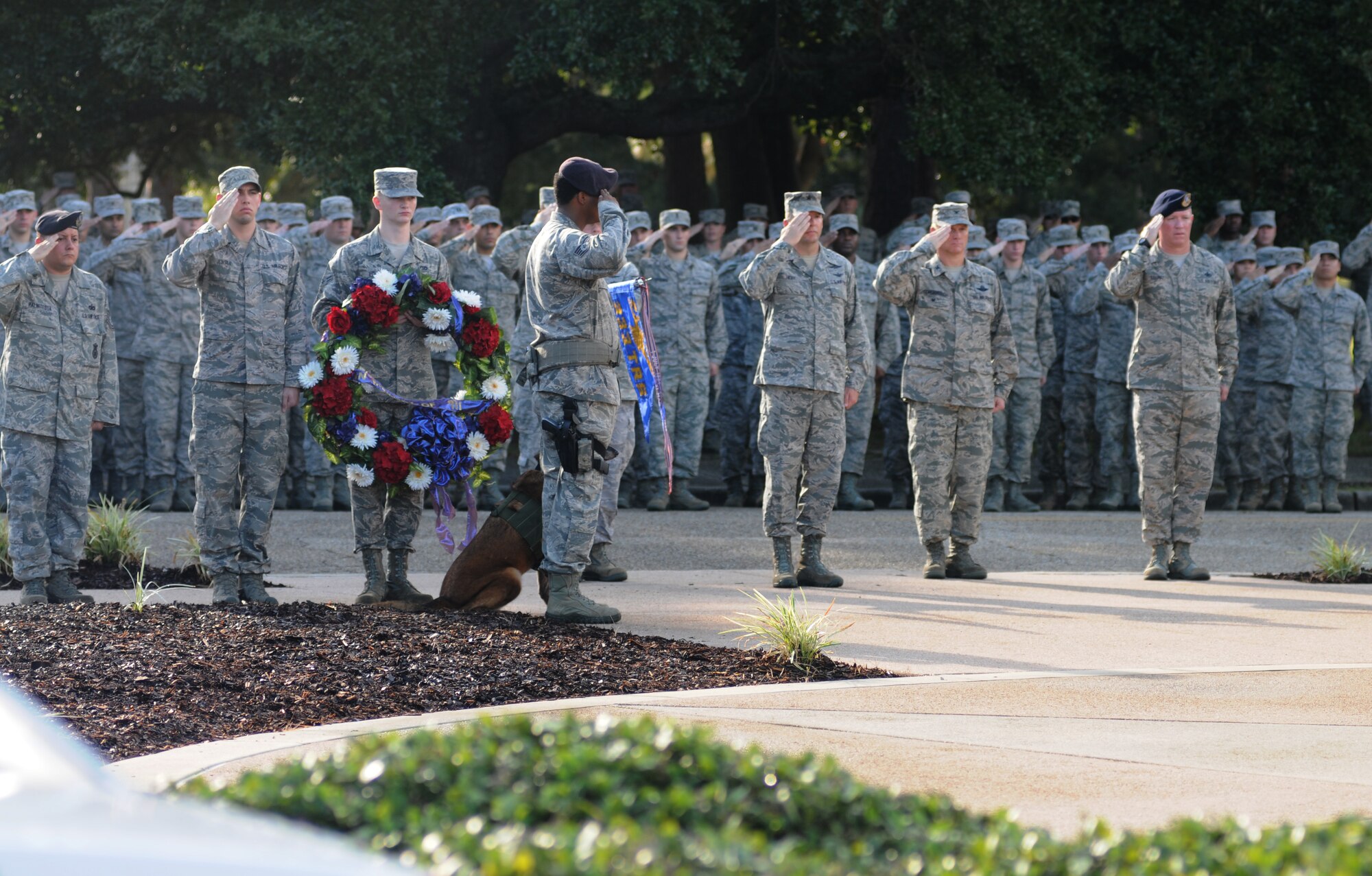 Keesler personnel render a salute as taps is played during a remembrance ceremony Sept. 11, 2014, Keesler Air Force Base, Miss. The ceremony honored those who lost their lives during the 9/11 attacks.  (U.S. Air Force photo by Kemberly Groue)