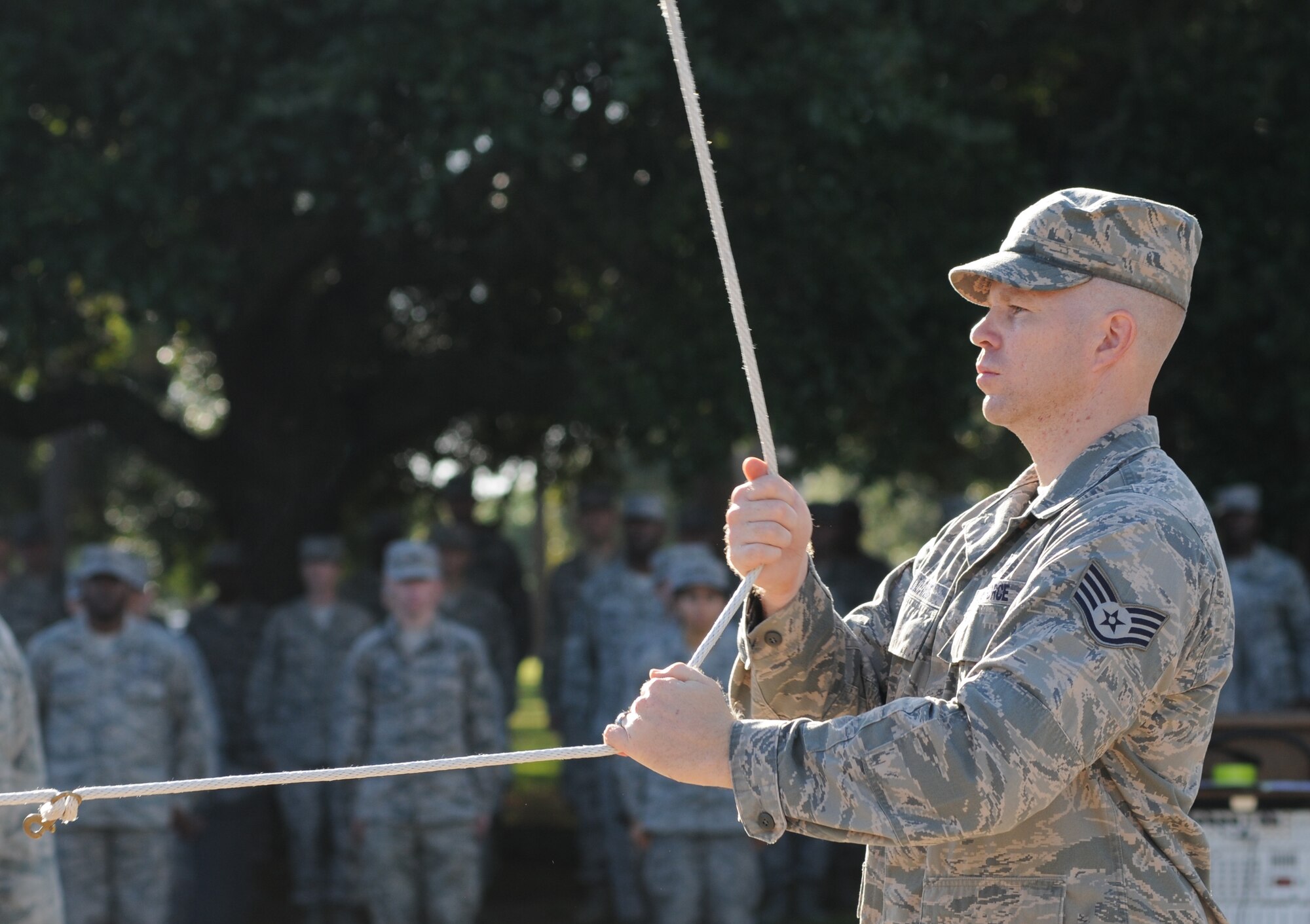 Staff Sgt. Joshua Williams, 333rd Training Squadron, lowers the flag to half-staff during a remembrance ceremony Sept. 11, 2014, Keesler Air Force Base, Miss. The ceremony honored those who lost their lives during the 9/11 attacks.  (U.S. Air Force photo by Kemberly Groue)