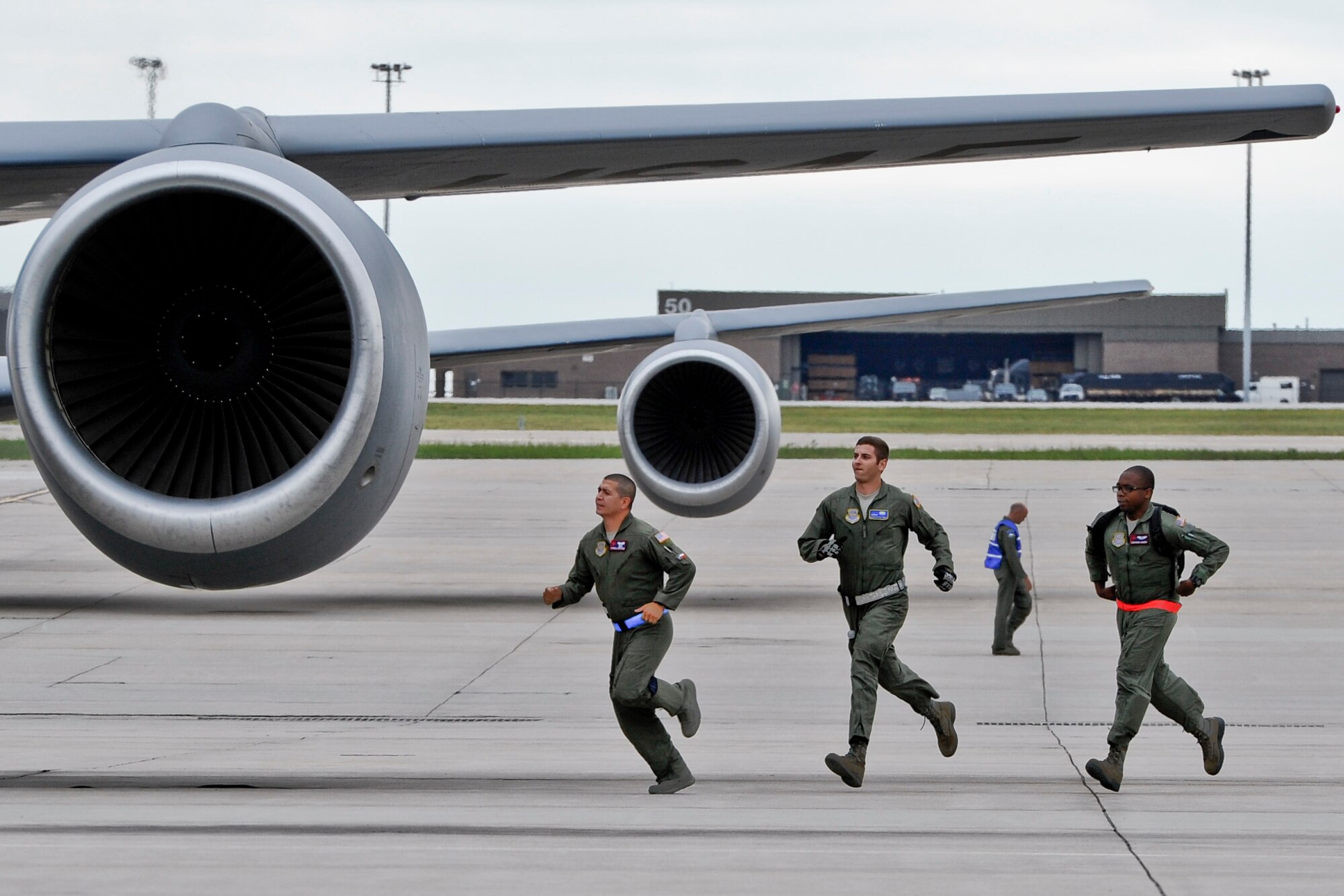 Aircrew members sprint toward a KC-135R Stratotanker Sept. 10, 2014, at McConnell Air Force Base, Kan. They rushed to prepare the aircraft for takeoff as part of a short notice training mission. (U.S. Air Force photo/Airman 1st Class John Linzmeier)  