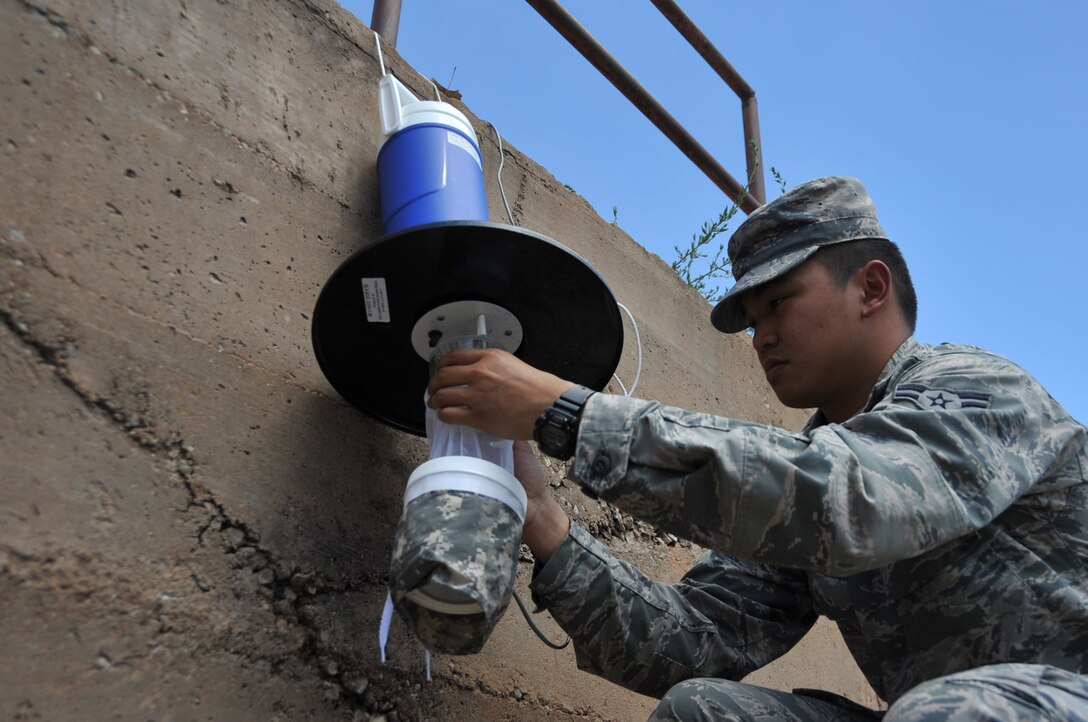 Airman 1st Class Karl Ambrosio, 82nd Aerospace Medicine Squadron public health technician, sets a mosquito trap Sept. 3, 2014, on Sheppard Air Force Base, Texas. Traps are placed in areas where mosquitoes thrive, such as where water is stagnant or high uncut grass exists.The 82nd AMDS public health flight has been trapping mosquitoes on base to test them for diseases such as West Nile Virus, Chikungunya Virus, Malaria and Dengue Fever. (U.S. Air Force photo/Airman 1st Class Robert L. McIlrath)


