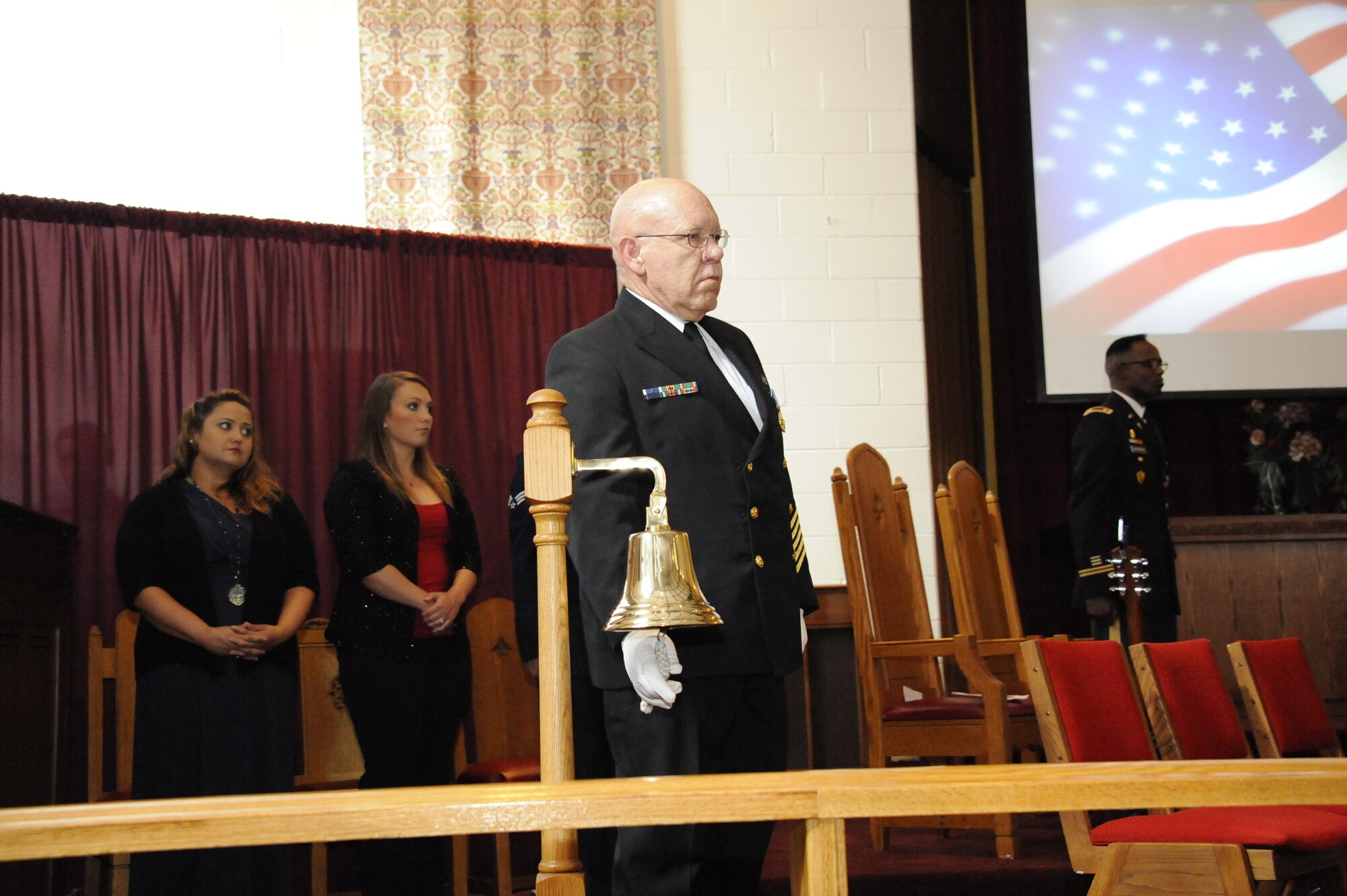 Chief Machinist’s Mate retired Arlan Davis, from Browns Mills, N.J., rings the Navy Bell four times for the four airplanes that crashed and killed so many on 9/11. (U.S. Air force photo by Pascual Flores/Released)