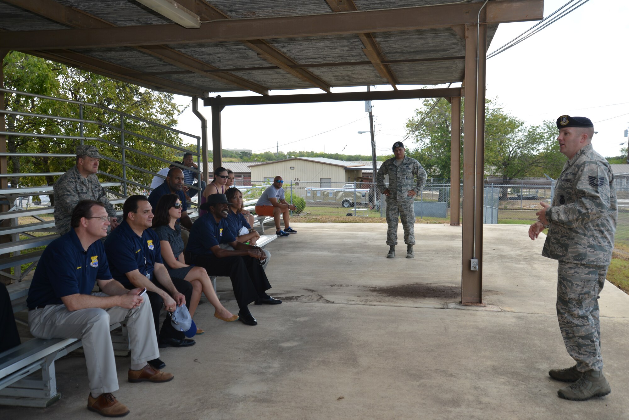 Tech. Sgt. Kevin Nelson, (forefront right) Military Working Dog Kennel Master, 802nd Security Forces Squadron briefs 433rd Airlift Wing Honorary Commanders on the history and the mission of the military working dog at Joint Base San Antonio-Lackland, Texas, Sept.6, 2014. (U.S. Air Force photo/Minnie Jones)