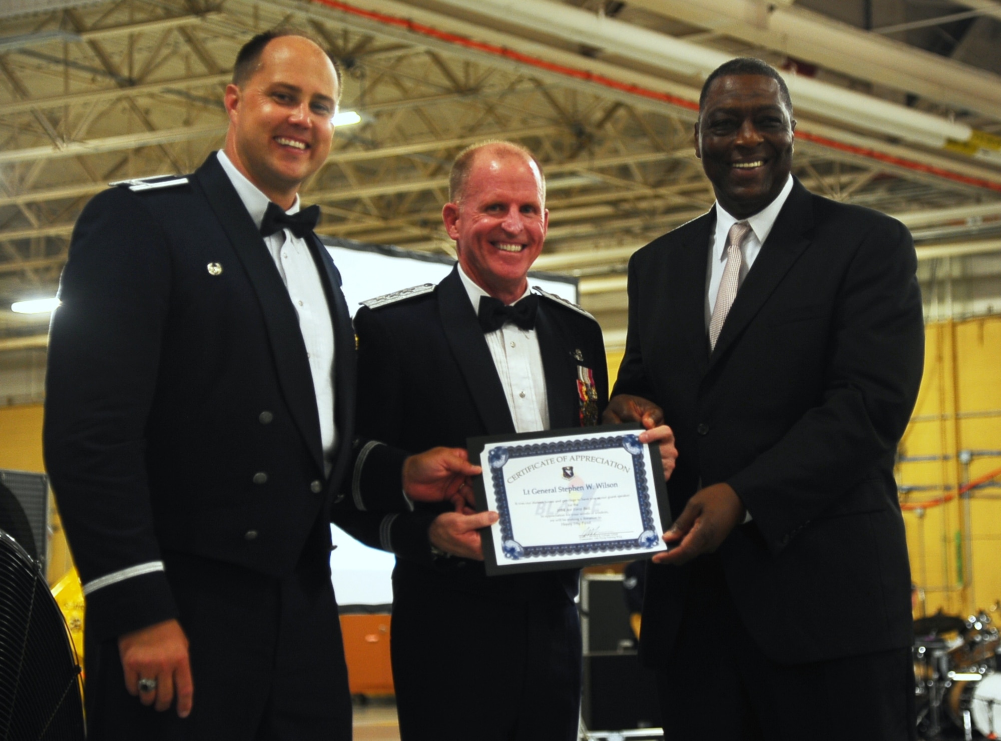 Col. John Nichols, 14th Flying Training Wing Commander, and Lt. Gen. Stephen Wilson, Air Force Global Strike Command Commander, present George Irby, Chairman of the Happy Irby Foundation and son of George Happy Irby, with a certificate of appreciation during the Air Force Ball Sept. 5 at the Mallory Hangar on Columbus Air Force Base. The ball included a performance from a Junior ROTC Saber Team and a speech from Wilson. (U.S. Air Force photo/Airman Daniel Lile)