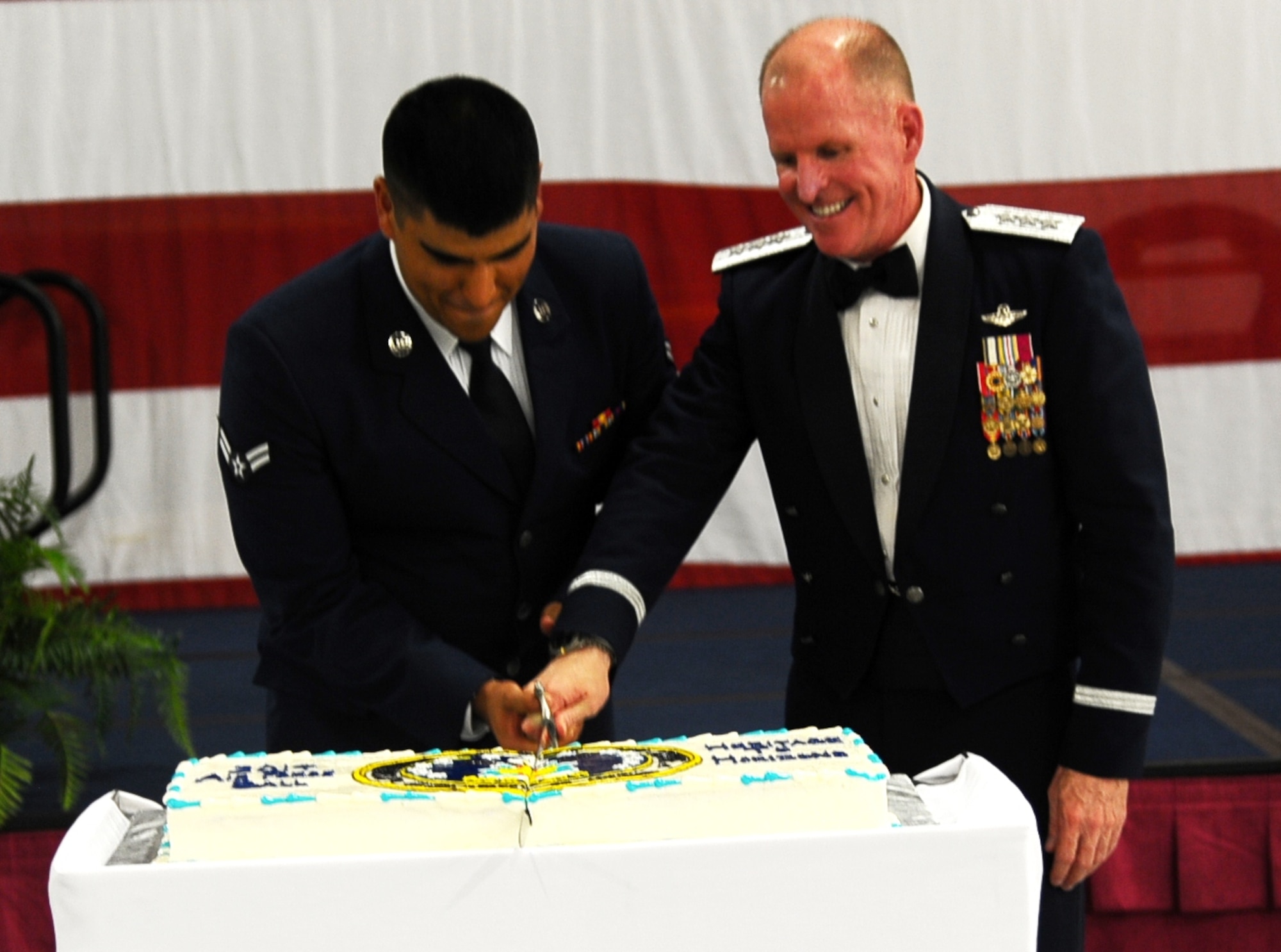 Lt. Gen. Stephen Wilson, Air Force Global Strike Command Commander, cuts the cake with Airman 1st Class Christian Pizarro, 14th Operations Support Squadron, during the Air Force Ball Sept. 5 at the Mallory Hangar on Columbus Air Force Base. The Air Force Birthday Ball has been a tradition for over 70 years, originating with the Army Air Corps. (U.S. Air Force photo/Airman Daniel Lile)