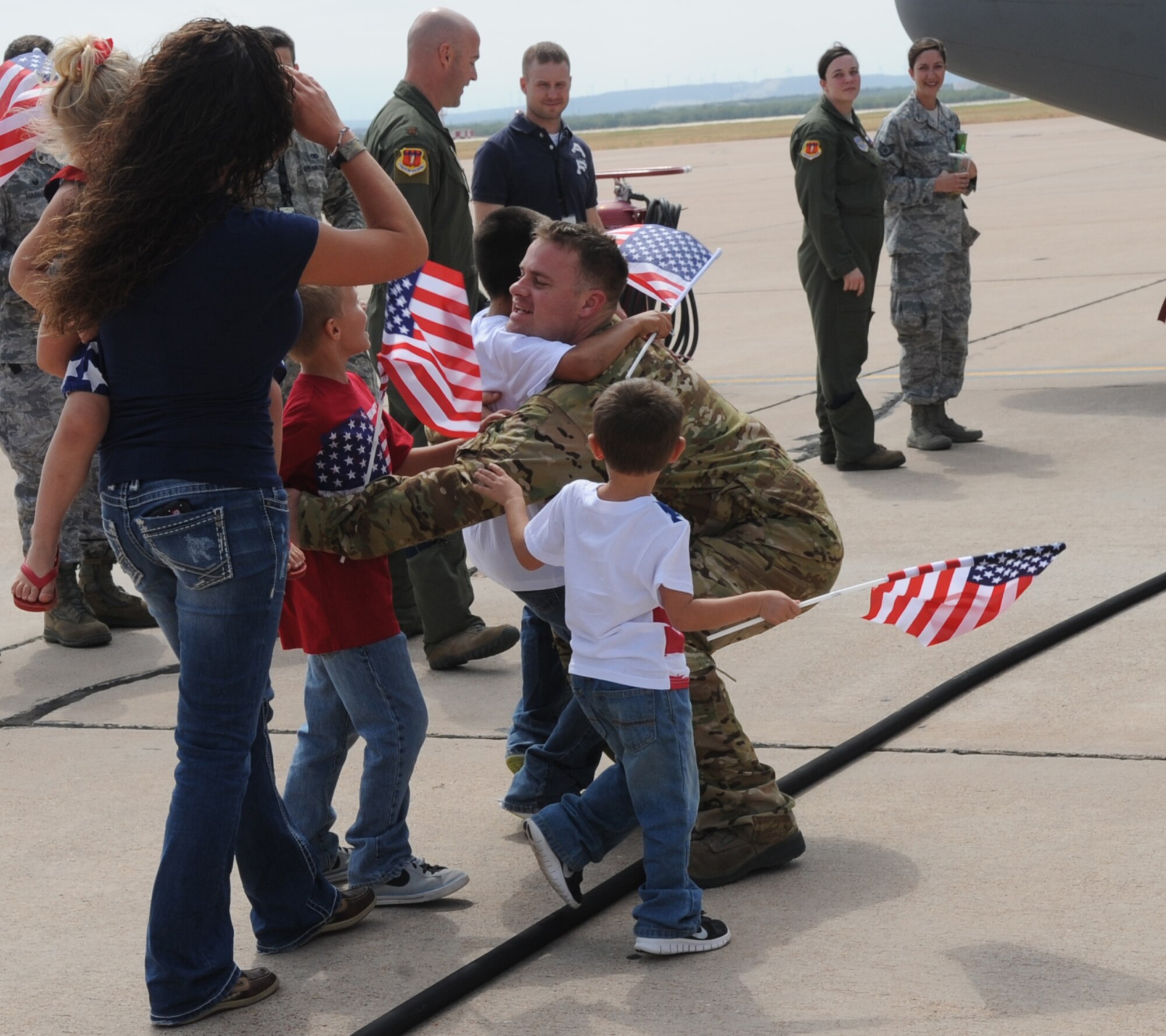 U.S. Air Force Tech. Sgt. David Liddell, 317th Aircraft Maintenance Squadron, greets his family Sept. 11, 2014, at Dyess Air Force Base, Texas. Liddell was part of a group of more than 20 Airmen that had been deployed in support of Operation Enduring Freedom and Horn of Africa operations. (U.S. Air Force photo by Senior Airman Shannon Hall/Released)