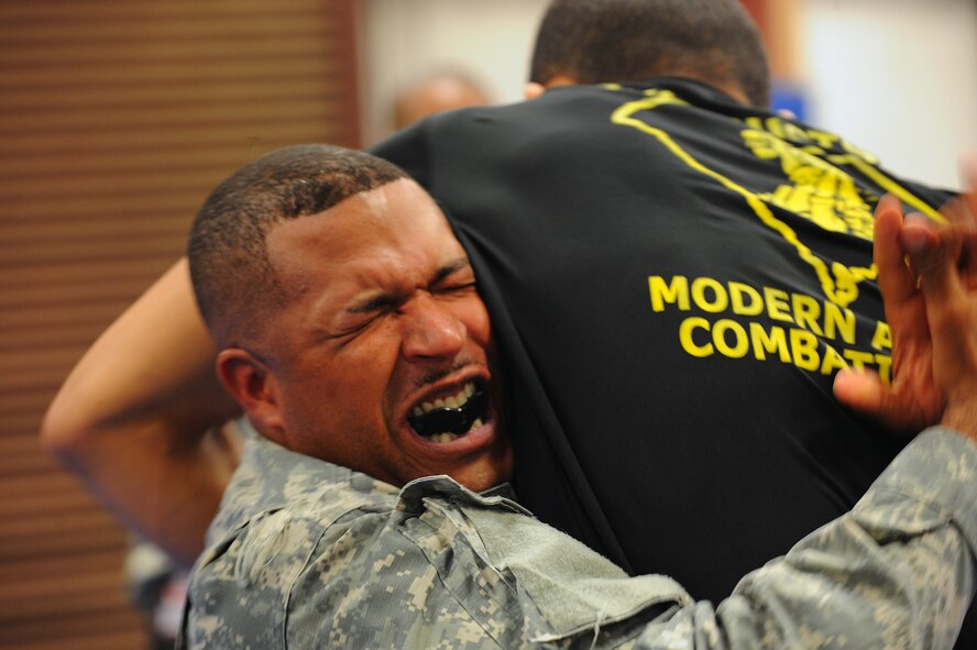 U.S. Army Capt. Michael McClure, U.S. Army Central G6 plans officer, attempts to grasp a Modern Army Combative Program instructor at Shaw Air Force Base, S.C., Sept. 10, 2014. Once a month instructors spend five days teaching students the basics of Jui Jitzu, a method of fighting designed to defeat an armed enemy without using a weapon. (U.S. Air Force photo by Airman 1st Class Michael Cossaboom/Released