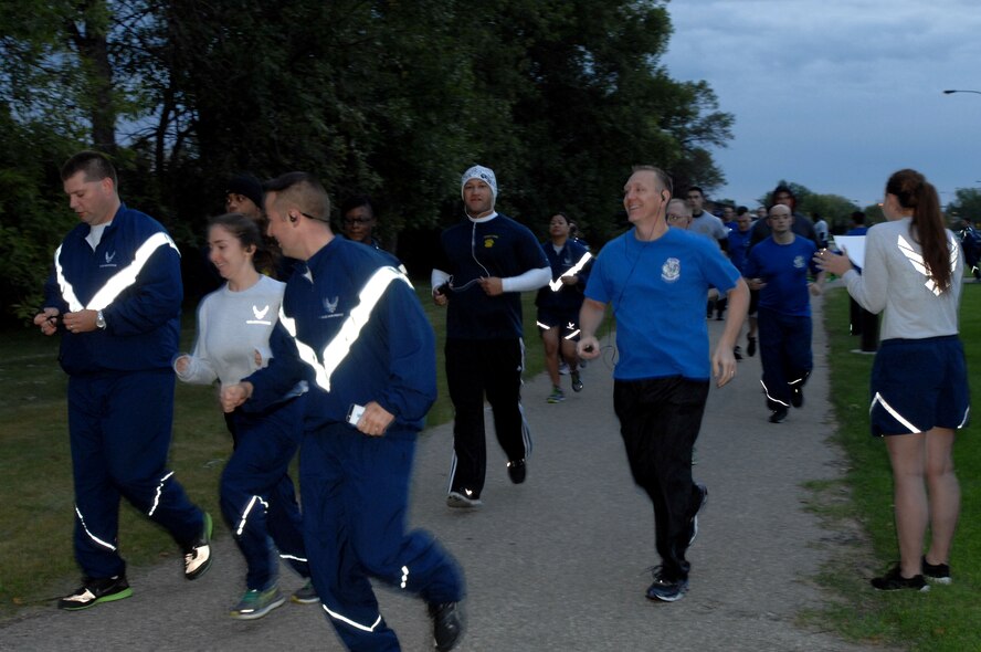 Runners from across Grand Forks Air Force Base cross the starting line Sept. 11, 2014, as they participate in a 5k and 9.11k run. The run was meant to commemorate the anniversary of the Sept. 11, 2001, terrorist attacks. (U.S. Air Force photo/Staff Sgt. Susan L. Davis)