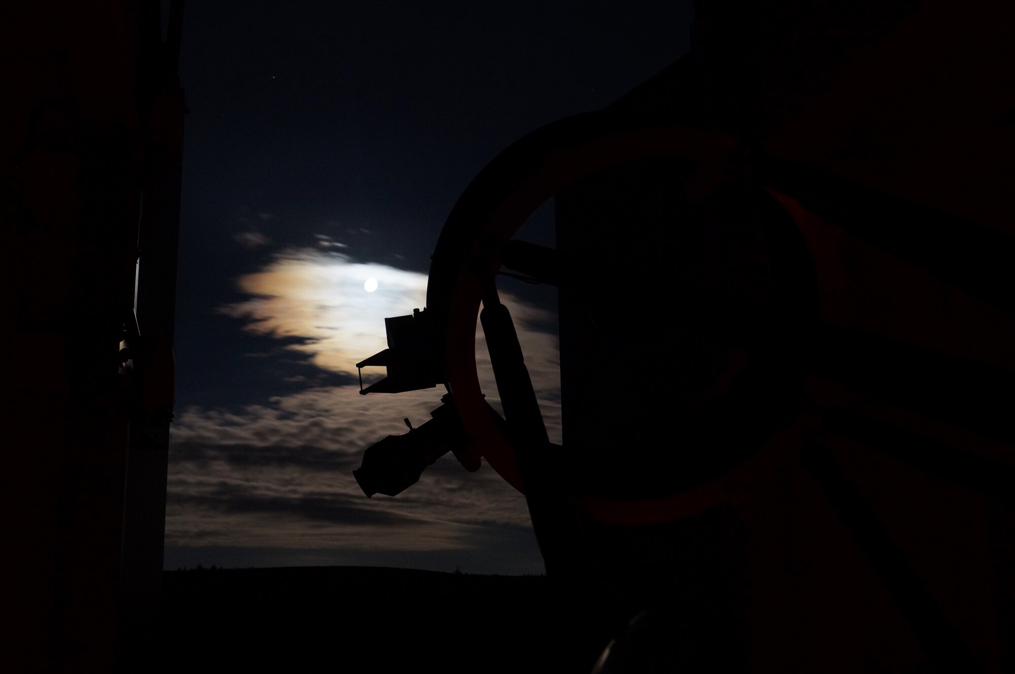 A telescope at the Kielder Observatory points to the moon through overcast skies. The observatory is located in England’s only International Dark Sky park and offers a variety of events, classes and workshops open to the public. (U.S. Air Force photo by Tech. Sgt. Eric Burks/Released)