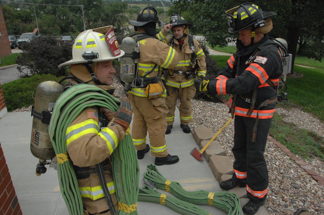 Offutt Air Force Base, Nebraska, firefighters prepare to climb 110 flights of stairs on the morning of Sept. 11 to honor the heroic efforts of the firefighters who responded to the World Trade Center Twin Towers on Sept. 11, 2001. The ceremony took place outside the 55th Communications Group building. (U.S. Air Force photo by 2nd Lt. Carly A. Costello)