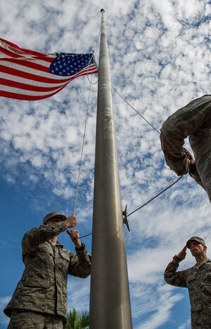 Airmen lower the flag during a 9/11 memorial retreat ceremony Sep. 11, 2014, at Joint Base Charleston, S.C. The retreat ceremony was a poignant reminder of the events of 13 years ago, and the continuing efforts today’s military is making against the War on Terrorism. (U.S. Air Force photo/Airman 1st Class Clayton Cupit)