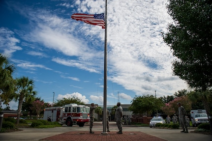 Airmen prepare to lower the colors during a 9/11 memorial ceremony Sep. 11, 2014, at Joint Base Charleston, S.C. The flag was flown at half staff through out the nation in memory of the victims of 9/11. The retreat ceremony was a poignant reminder of the events of 13 years ago, and the continuing efforts today’s military is making against the War on Terrorism. (U.S. Air Force photo/Airman 1st Class Clayton Cupit)