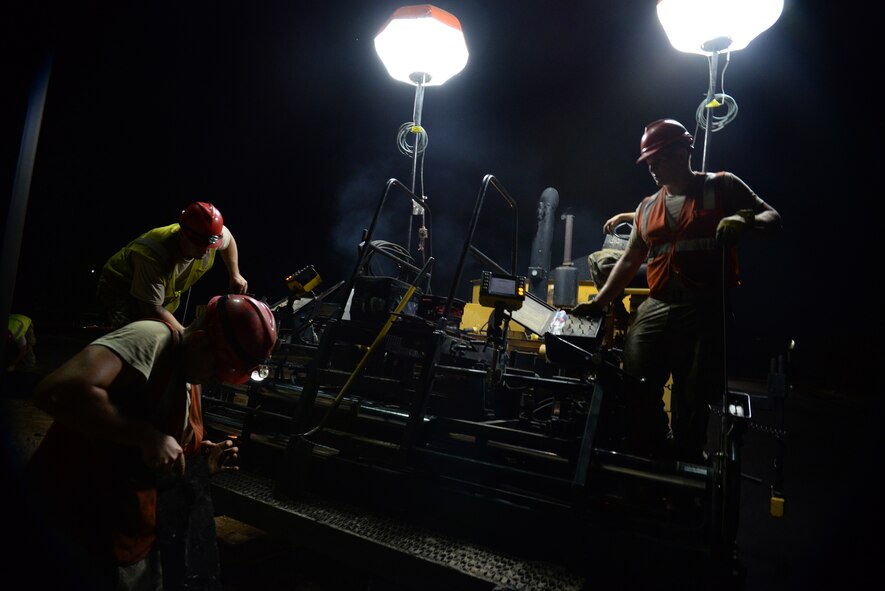 [From left] U.S. Air Force Senior Airman John Carroll, Airman 1st Class Casey Kutlik and Senior Airman Derek Purdin, all 823rd Rapid Engineer Deployable Heavy Operational Repair Squadron Engineers pavements and equipment operator journeymen, assigned to Hurlburt Field, Fla., operate a paver at Shaw Air Force Base, S.C., Sept. 10, 2014. The paver is used to smooth large sections of hot asphalt on the road. RED HORSE units are fully self-sufficient for up to 30 days during a deployment. (U.S. Air Force photo by Airman 1st Class Jonathan Bass/Released)