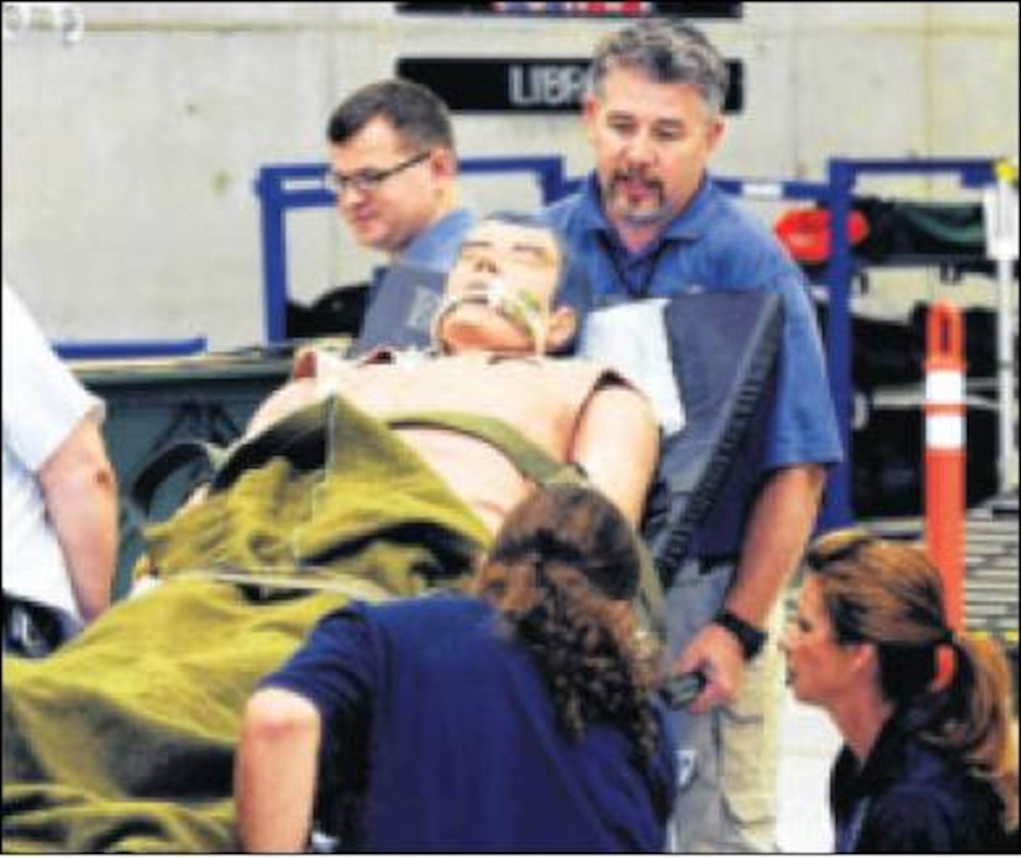 Team members accept a mannequin portraying a patient during the training event. (Air Force photo by Wesley Farnsworth)