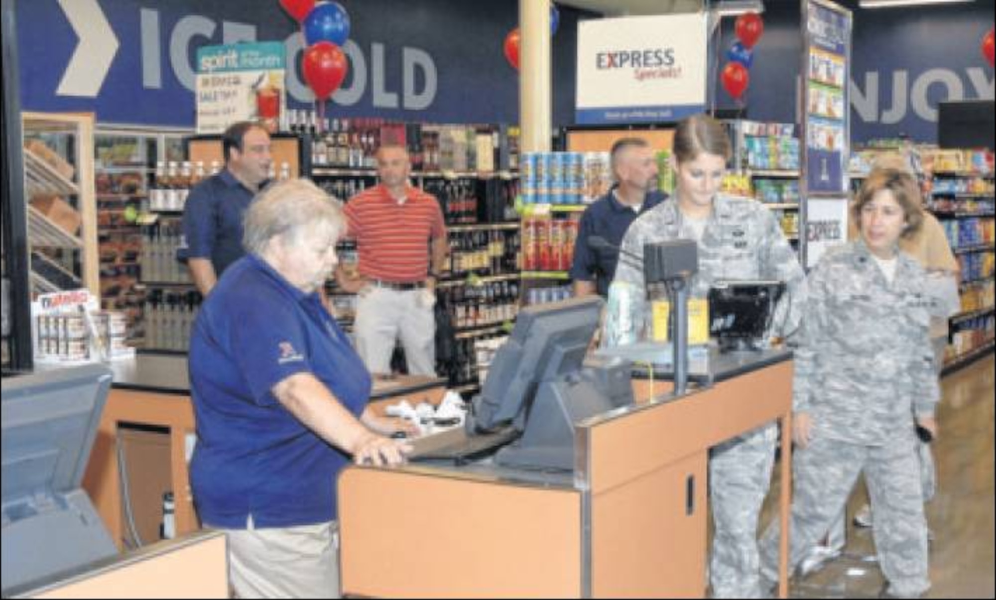 Store associate Judy Holly rings up a purchase by 1st Lt. Krystin Cooper, 88th Mission Support Group, Sept. 9 following the grand opening of the new shopette/gas station. (Air Force photo by Al Bright)