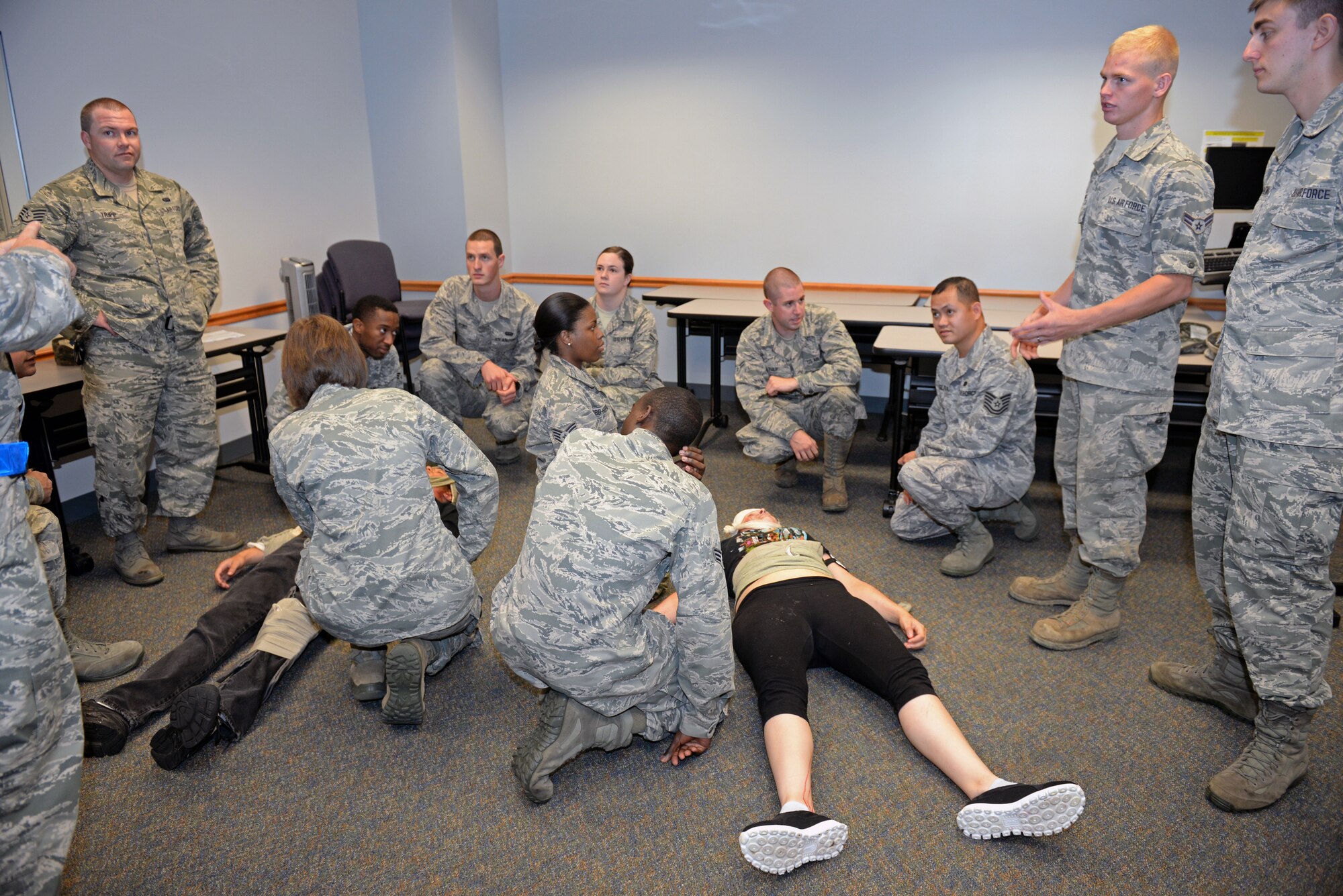375th Communications Group Airmen practice Self-Aid & Buddy Care training on simulated victims at the Education Center, Scott Air Force Base, Ill., Sept. 8, 2014. The victims had a variety of 'injuries', including head injuries, severe bleeding requiring tourniquets, broken bones, and amputees. These 150 personnel, through this training, fulfilled their requirement of SABC training to be deployment-ready. (U.S. Air Force photo by Airman 1st Class Erica Crossen)