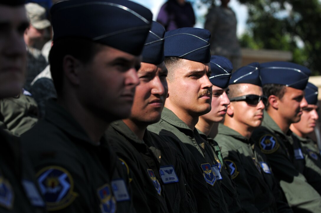 Attendees from the 47th Student Squadron observe the events of a Sept. 11 remembrance retreat ceremony on Laughlin Air Force Base, Texas, Sept. 11, 2014. Attendees were reminded of the 102 minutes on September 11, 2001 that impacted thousands of first responders and took the lives of nearly 3,000 people. (U.S. Air Force photo by Staff Sgt. Steven R. Doty)(Released)