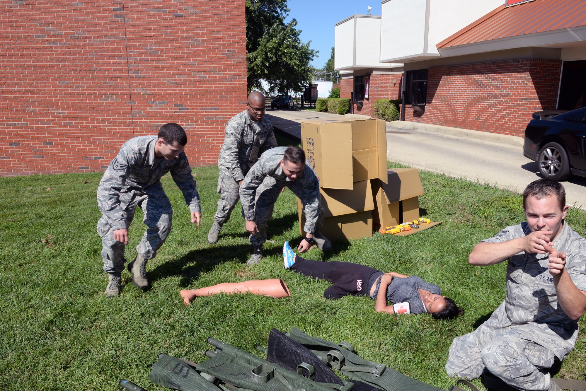 375th Communications Group Airmen prepare to transport a victim during Self-Aid & Buddy Care training at the Education Center, Scott Air Force Base, Ill., Sept. 8, 2014. The Airmen encountered and tended to simulated victims who had a variety of 'injuries', including head injuries, severe bleeding requiring tourniquets, broken bones, and amputations. These 150 personnel, through this training, fulfilled their requirement of SABC training to be deployment-ready. (U.S. Air Force photo by Airman 1st Class Erica Crossen)