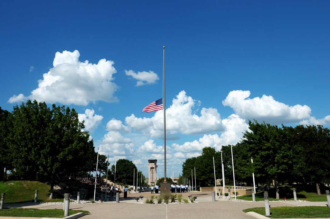 Laughlin Air Force Base’s installation flag rests at half-staff at a Sept. 11 remembrance retreat ceremony here, Sept. 11, 2014. When a flag is at half-staff, it is one-half the distance between the top and bottom of the staff and symbolizes respect or mourning for a significant individual(s) or event. (U.S. Air Force photo by Staff Sgt. Steven R. Doty)(Released)