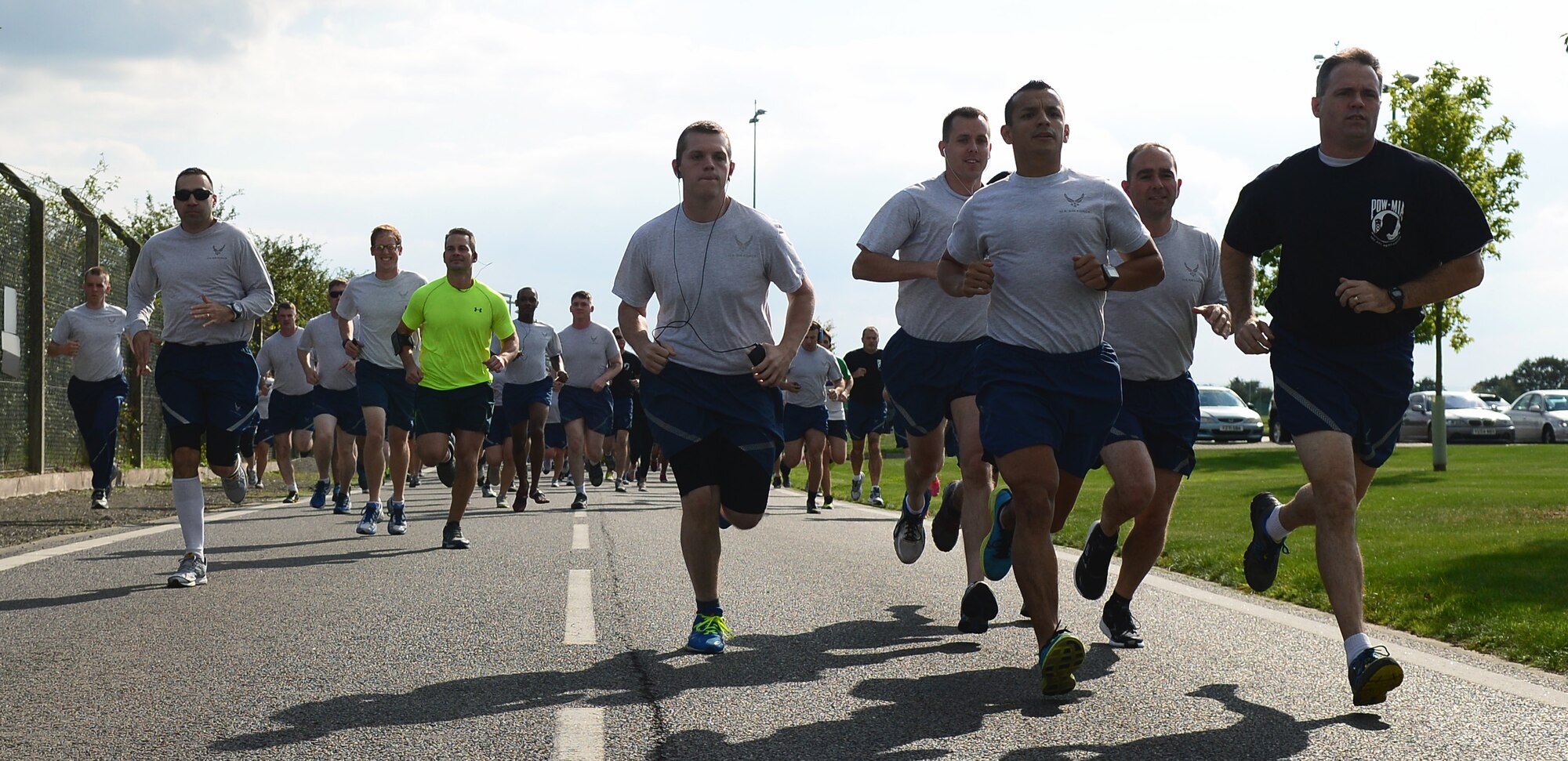 Team Mildenhall members kick off the 100th Air Refueling Wing 5 km run in honor of Prisoner of War/Missing in Action Week of Remembrance Sept. 12, 2014, on RAF Mildenhall, England. Starting at the Hardstand Fitness Center, participants run along a designated base perimeter route. (U.S. Air Force photo/Airman 1st Class Jonathan Light/Released)