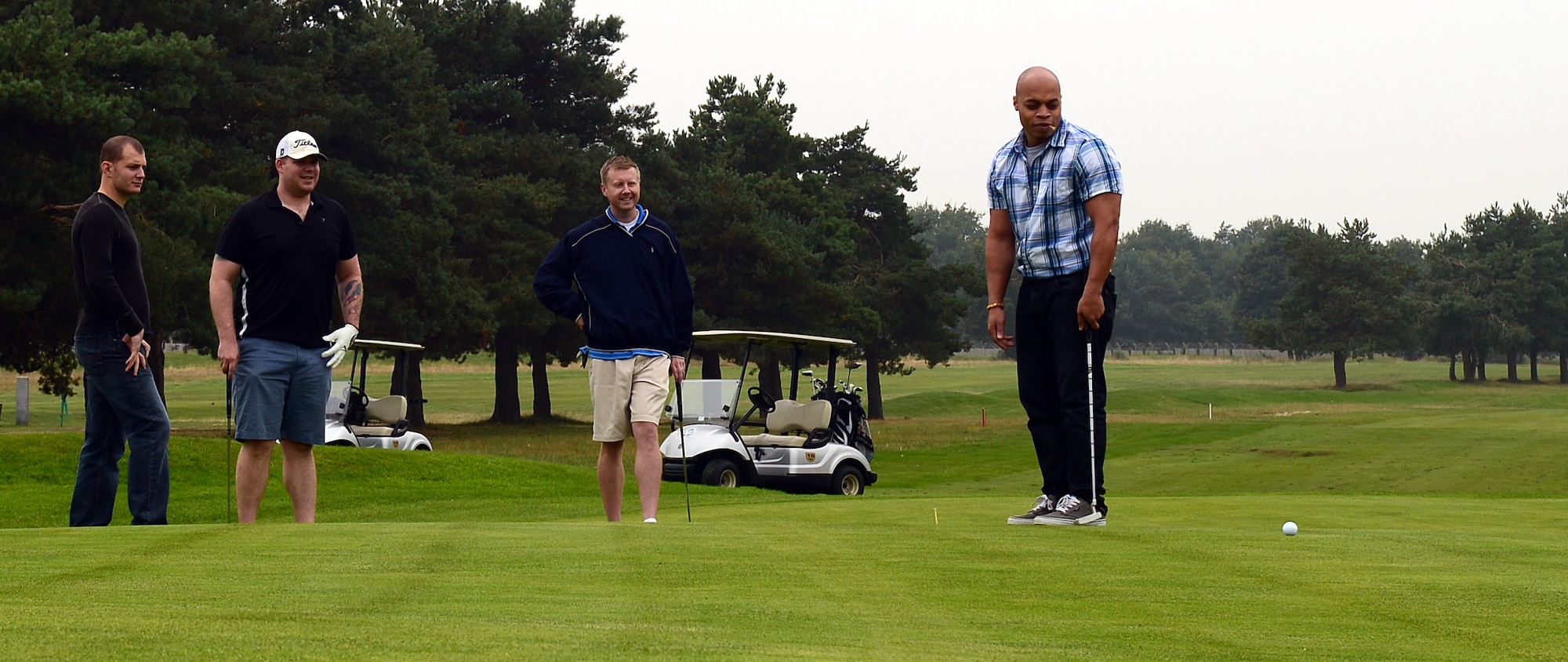 Airmen attend a Combined Federal Campaign golf tournament Sept. 11, 2014, at the Breckland Pines Golf Club on RAF Lakenheath, England.  The campaign is an annual federal fundraiser which gives federal employees the opportunity to donate to any of the nonprofit charity organizations registered to the CFC. (U.S. Air Force photo/Airman 1st Class Jonathan Light/Released)