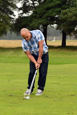 U.S. Air Force Senior Airman Thomas Hull, 38th Reconnaissance Squadron Airborne Systems engineer assigned to Offutt Air Force Base, Neb. and from Detroit, chips a golf ball during a Combined Federal Campaign golf tournament Sept. 11, 2014, at the Breckland Pines Golf Club on RAF Lakenheath, England.  The campaign is an annual federal fundraiser benefitting nonprofit charity organizations.. (U.S. Air Force photo/Airman 1st Class Jonathan Light/Released)