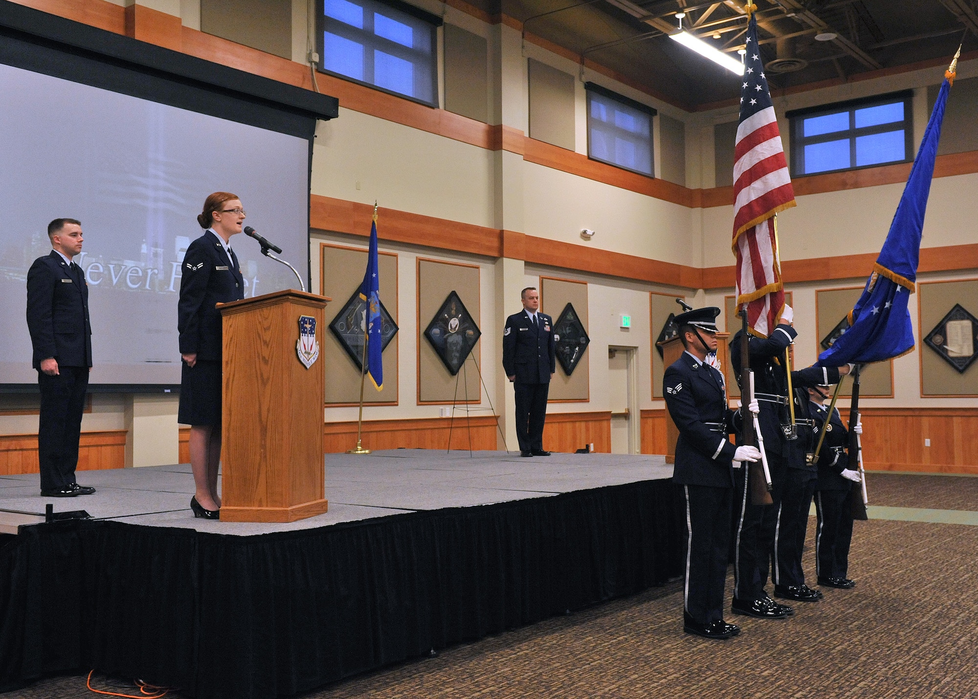 Airman 1st Class Courtney Gardner, 341st Force Support Squadron chef, sings the national anthem as the Malmstrom Honor Guard presents the colors at the start of the “In Remembrance of 9-11” memorial ceremony Sept. 11 at the Grizzly Bend. (U.S. Air Force photo/John Turner)