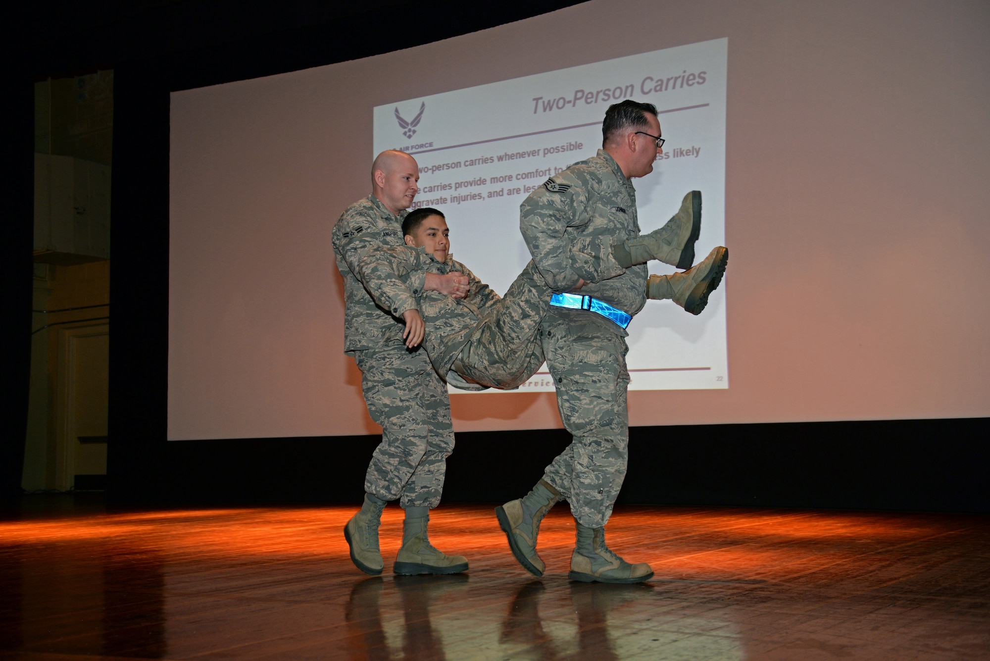375th Communications Squadron Airmen volunteered to demonstrate different victim carry positions, showing what would be performed during the hands-on portion by the Airmen needing to fulfill training requirements for the Self-Aid & Buddy Care training at the Education Center, Scott Air Force Base, Ill., Sept. 8, 2014. Two groups went through this training in one day, and 150 personnel, through this training, fulfilled their requirement of SABC training to be deployment-ready. (U.S. Air Force photo by Airman 1st Class Erica Crossen)