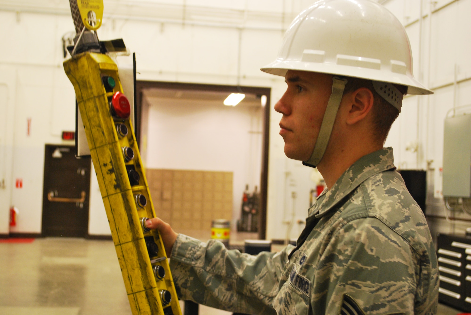 Senior Airman Justin Ford, 341st Munitions Squadron technician, operates a hoist during a training session at Malmstrom Air Force Base Aug. 21. During the 2014 Global Strike Challenge, Malmstrom’s 341st MUNS team will transfer, install and troubleshoot a Mark 12A missile assembly (U.S. Air Force photo/Airman 1st Class Collin Schmidt)