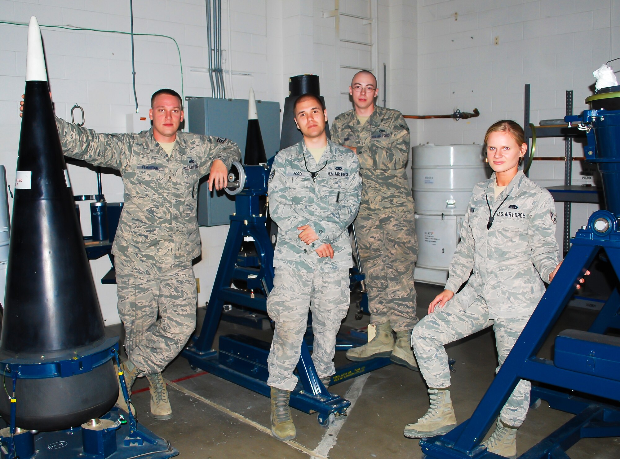 (From left to right) Staff Sgt. James Flanigan, Senior Airman Andrew Ford, and Airmen 1st Class Matthew Gish and Jennifer Cook, 341st Munitions Squadron team, pose for a photograph after a training session at Malmstrom Air force Base Aug. 21. The team is one of nine from the base that will be competing in the 2014 Global Strike Challenge. (U.S. Air Force photo/Airman 1st Class Collin Schmidt)