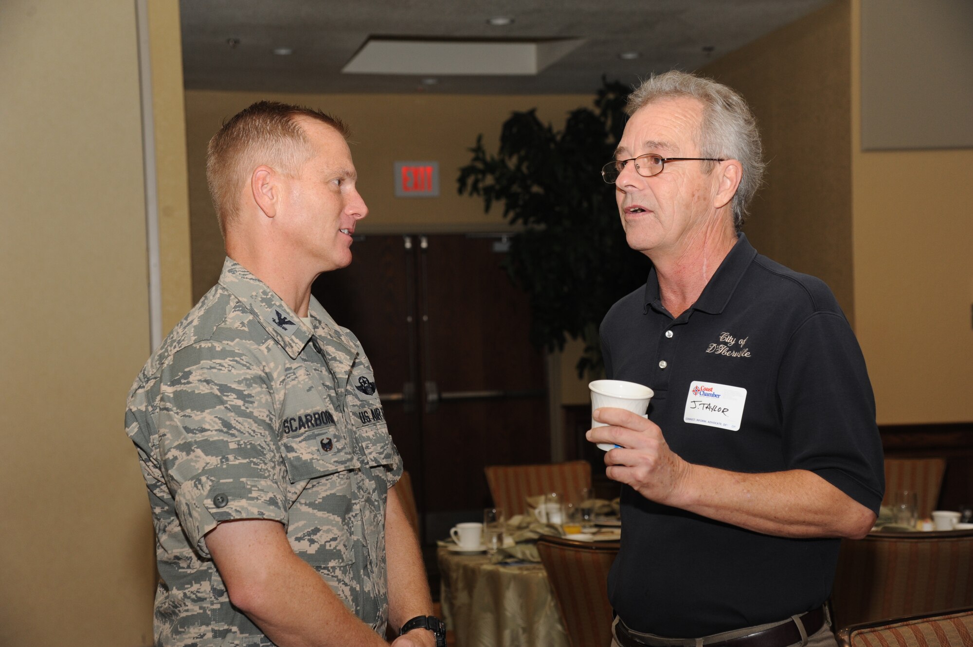 Col. Dennis Scarborough, 81st Training Wing vice commander, speaks with Jeff Taylor, City of D’Iberville city planner, during the Biloxi Chamber of Commerce Morning Call Sept. 10, 2014, hosted by Keesler Air Force Base, Miss., at the Bay Breeze Event Center. (U.S. Air Force photo by Kemberly Groue)