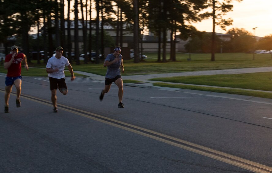 Participants of the “We remember 9/11 5K Run” sprint to the finish line Sept. 11, 2014, at Moody Air Force Base, Ga. More than 50 people from various organizations on base completed the event in honor of the 2,945 victims of Sept. 11 and those lost from the resulting conflicts. (U.S. Air Force photo by Staff Sgt. Eric Summers Jr./Released)