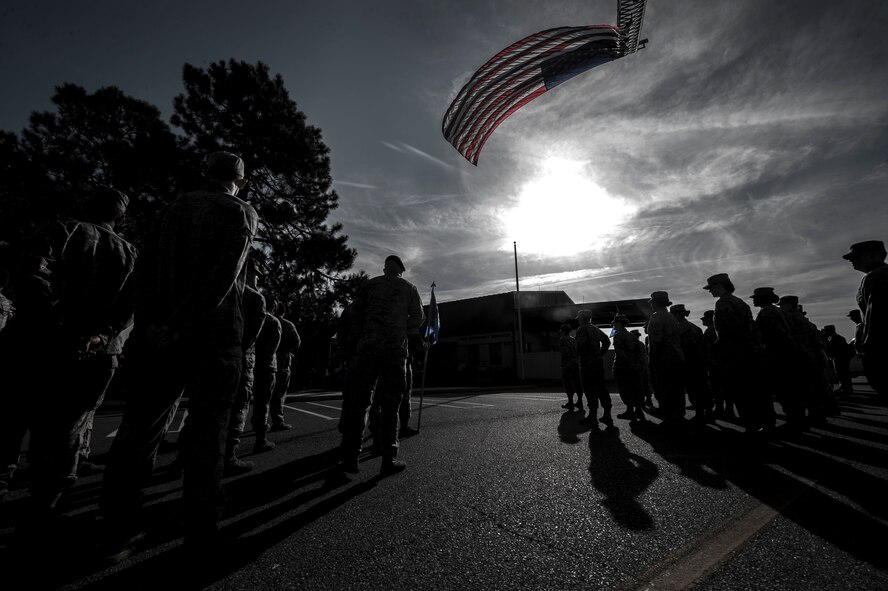 Members out of the 23d Security Forces and Civil Engineer Squadrons stand in formation during a 9/11 remembrance ceremony Sept. 11, 2014, Moody Air Force Base, Ga. The firefighters and patrolmen honor the 403 firefighters, paramedics and New York City police officers who sacrificed their lives on 9/11. (U.S. Air Force photo by Airman 1st Class Dillian Bamman/Released)