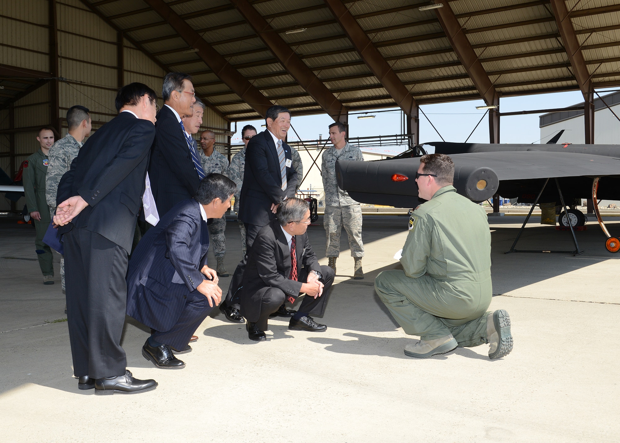A U-2 pilot with the 9th Reconnaissance Wing explains the function of the titanium skidplates on the wingtips of the "Dragon Lady" to delegates of the Japan-American Air Force Goodwill Association during a visit to Beale Air Force Base, Calif., Sept. 10, 2014. (U.S. Air Force photo by John Schwab/Released)