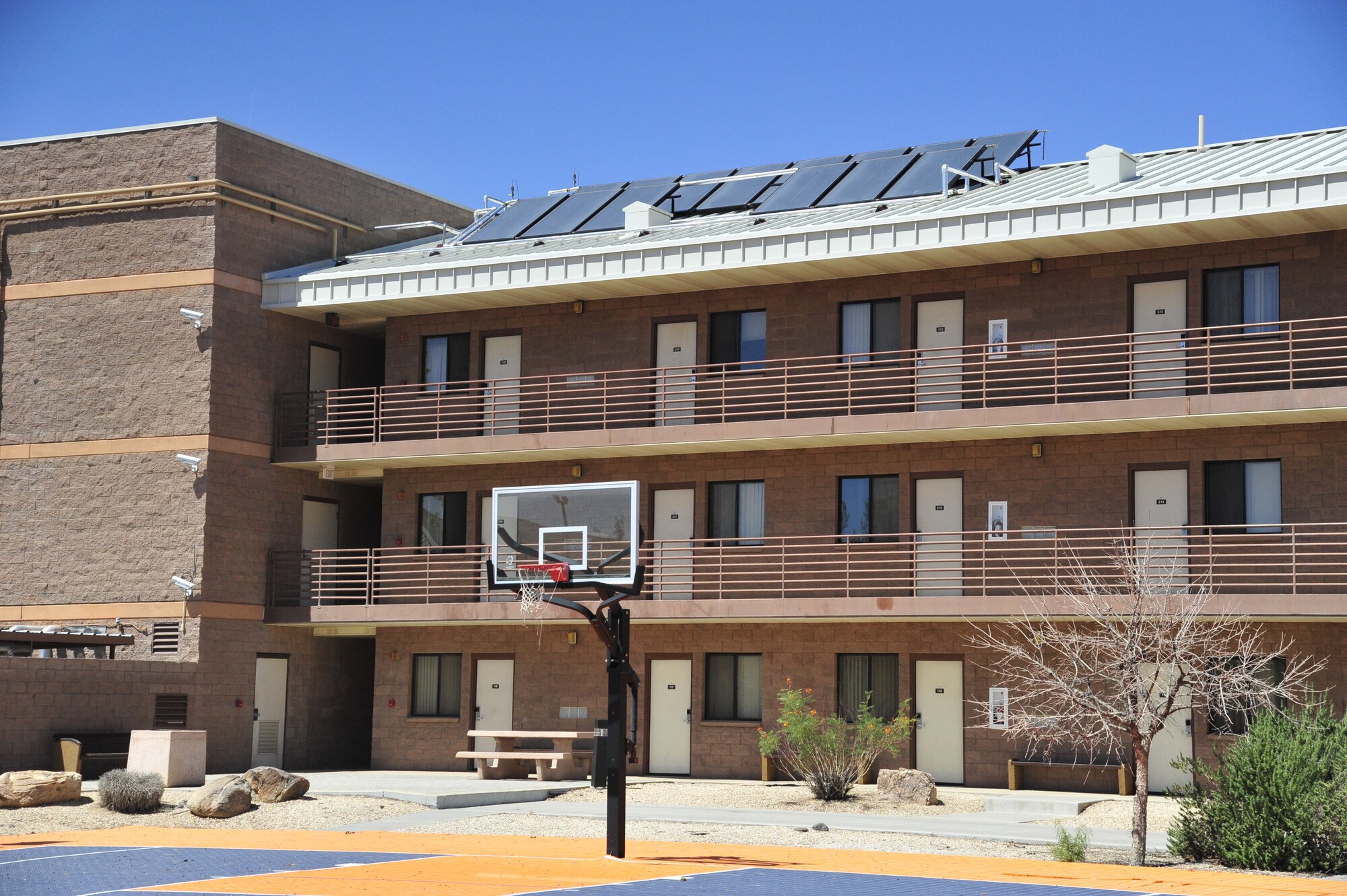 A solar array panel stands on a dormitory roof Sept. 3 at Luke Air Force Base. There are currently four active solar arrays on base. The solar array shown will produce hot water to the dormitory. (U.S. Air Force photo/Senior Airman Grace Lee)