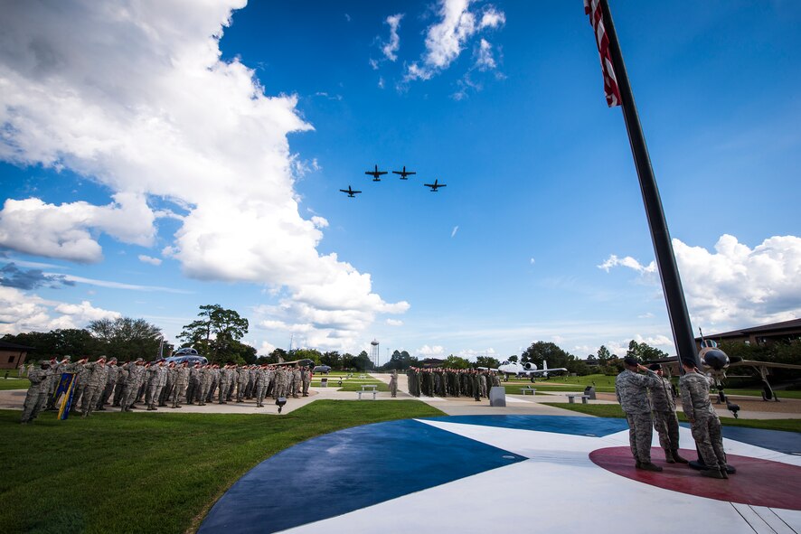 Four A-10C Thunderbolt II aircraft from the 23d Fighter Group fly over a 9/11 remembrance ceremony Sept. 11, 2014, at Moody Air Force Base, Ga.  The pilots flew a missing-man formation, a symbolic ‘aerial salute,’ to honor the lives lost in the Sept. 11 terrorist attacks and resulting conflicts. (U.S. Air Force photo by Airman 1st Class Ryan Callaghan/Released)