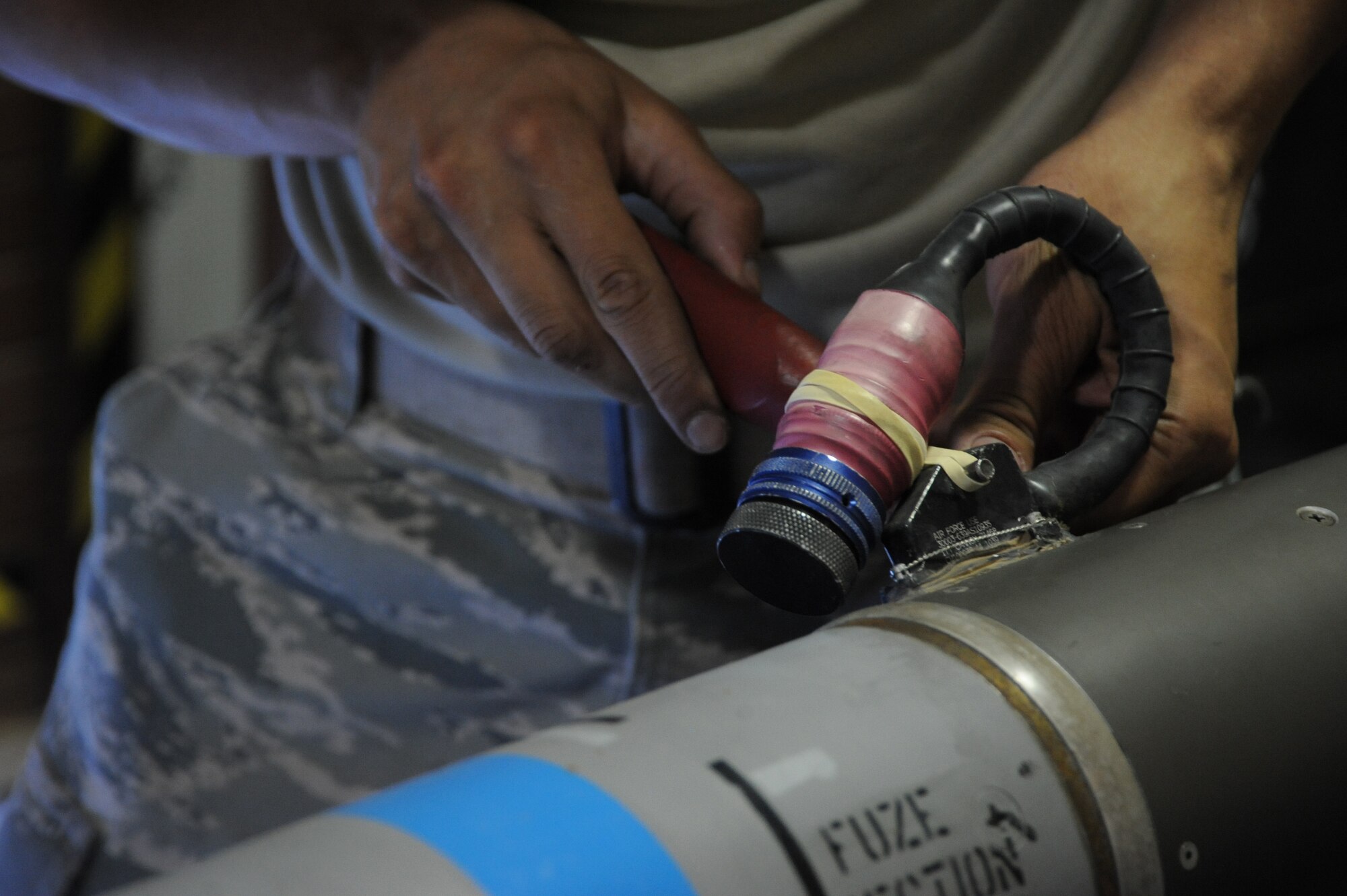 An Airman with the 56th EMS tightens a bolt on a captive air missile. CATM-M9 missiles are one of the many types of precision-guided munitions worked on by weapons maintainers. (U.S. Air Force photo/Airman 1st Class James Hensley)