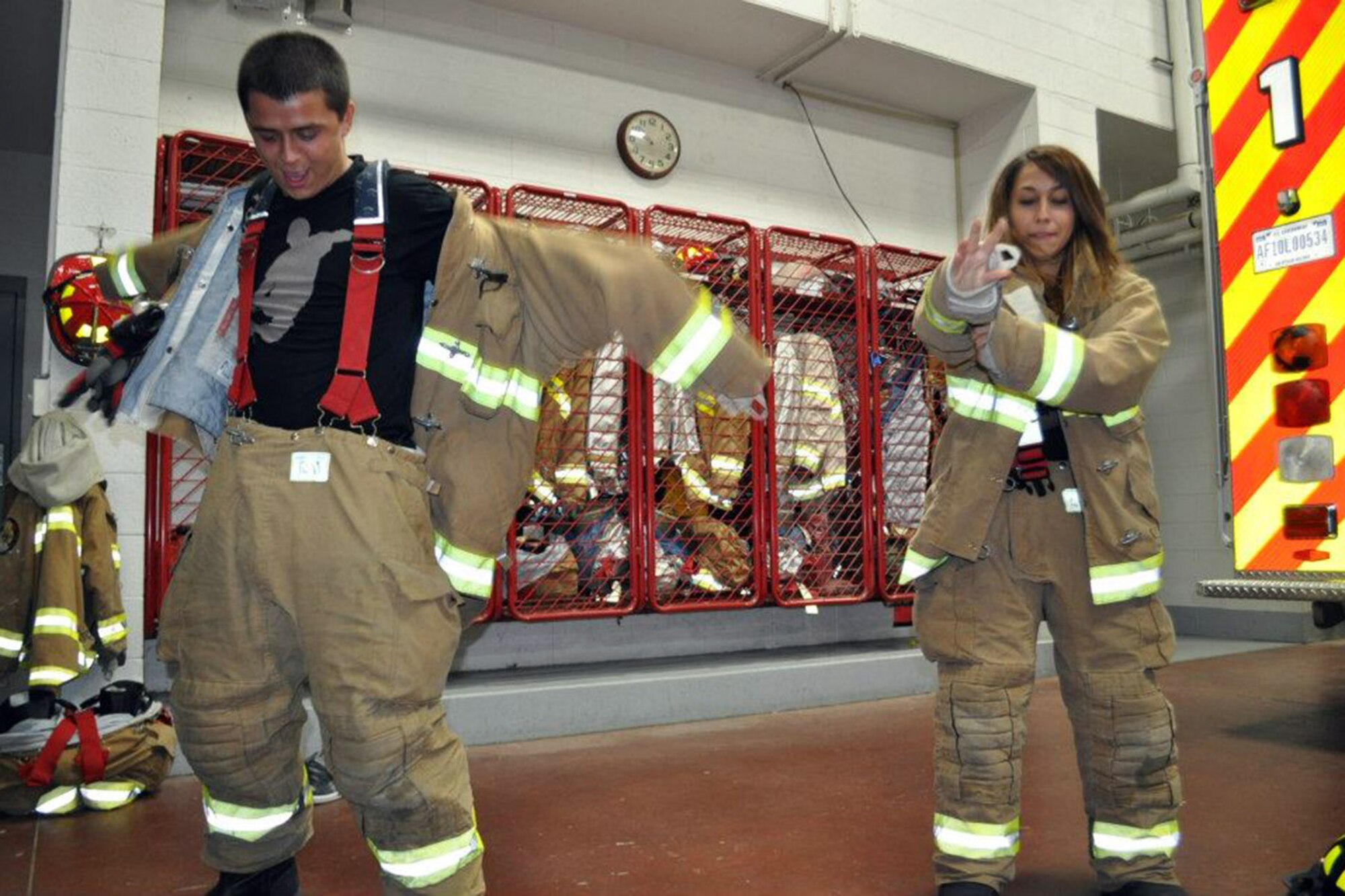 YOUNGSTOWN AIR RESERVE STATION, Ohio – YARS Teens try their hand at putting on Personnel Protective Equipment at the 910th Civil Engineer Fire Department here while participating in the 2013 YARS Annual Teen Lock-In.  The upcoming 4th YARS Annual Teen Lock-in is scheduled to take place here, 9am until 8pm, Saturday Oct. 11, 2014. See story to left for more event information. Courtesy Photo.