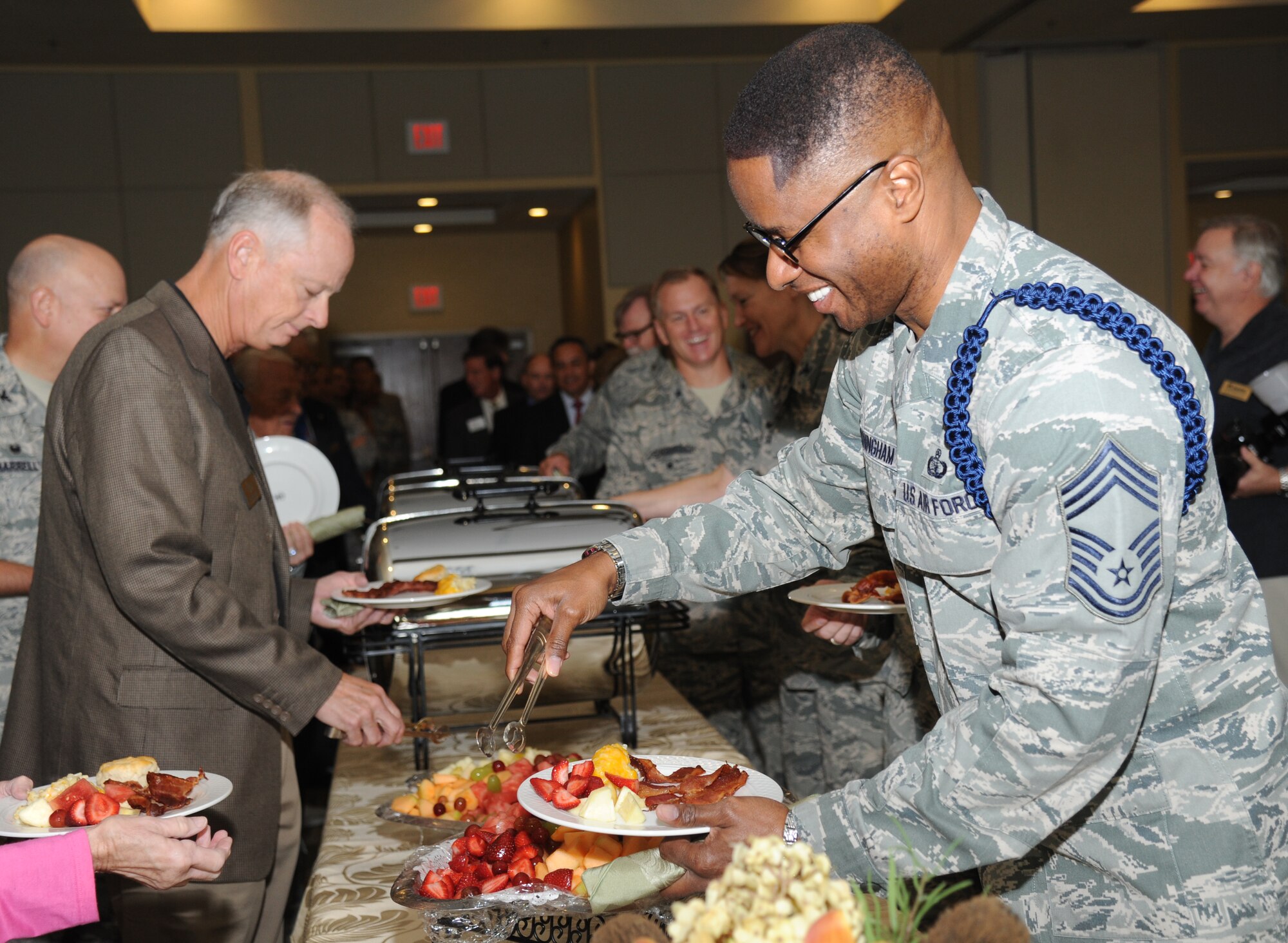 Chief Master Sgt. Roderick Cunningham, Air Force Reserve Command Liaison, makes his way through the buffet line during the Biloxi Chamber of Commerce Morning Call Sept. 10, 2014, hosted by Keesler Air Force Base, Miss., at the Bay Breeze Event Center.  (U.S. Air Force photo by Kemberly Groue)