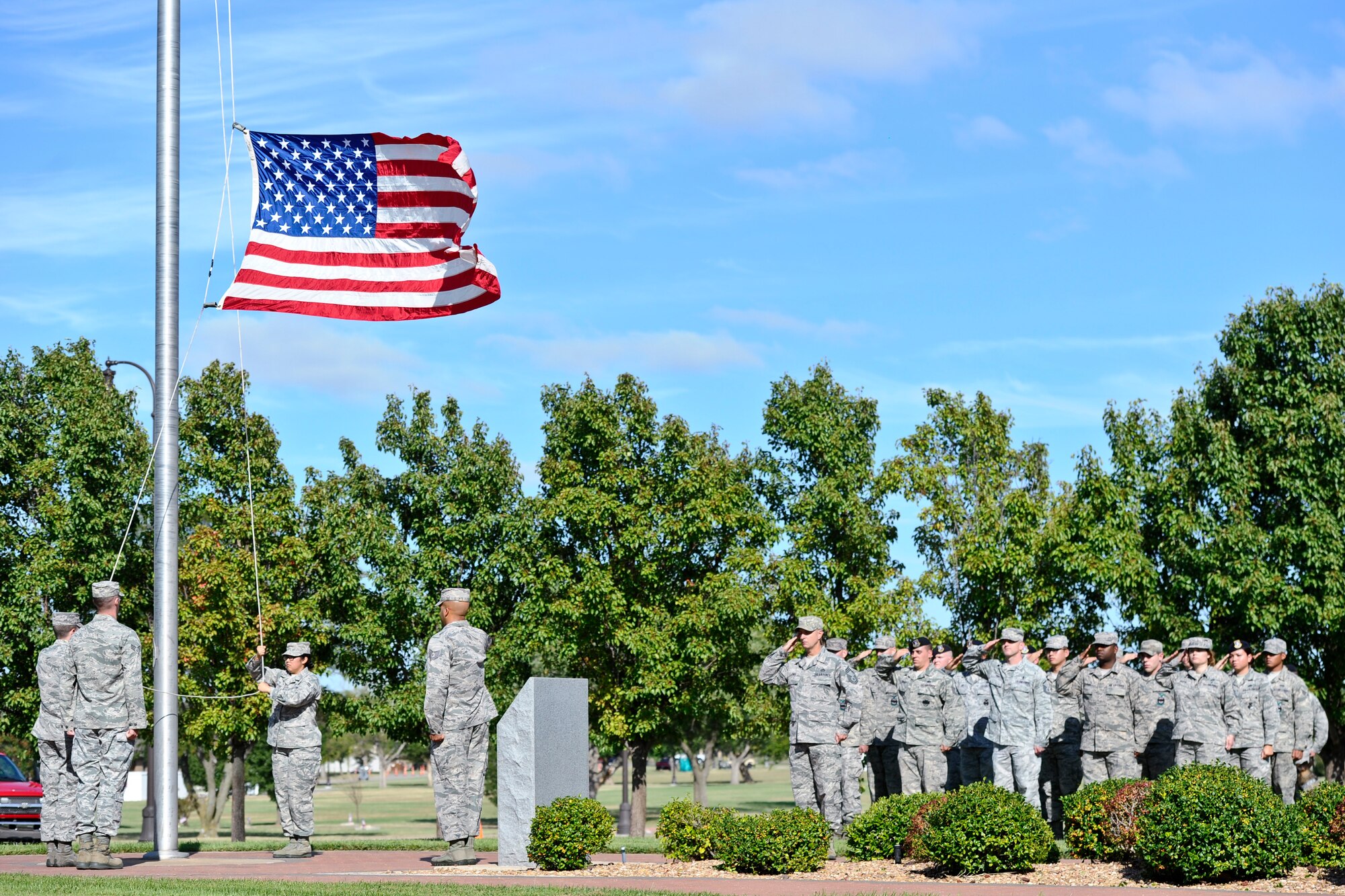 Airmen lower the American Flag during a Patriot Day ceremony Sept. 11, 2014, at McConnell Air Force Base, Kan. The ceremony was held in honor of the nearly 3,000 people who died during the 9/11 attacks. (U.S. Air Force photo/Airman 1st Class John Linzmeier)