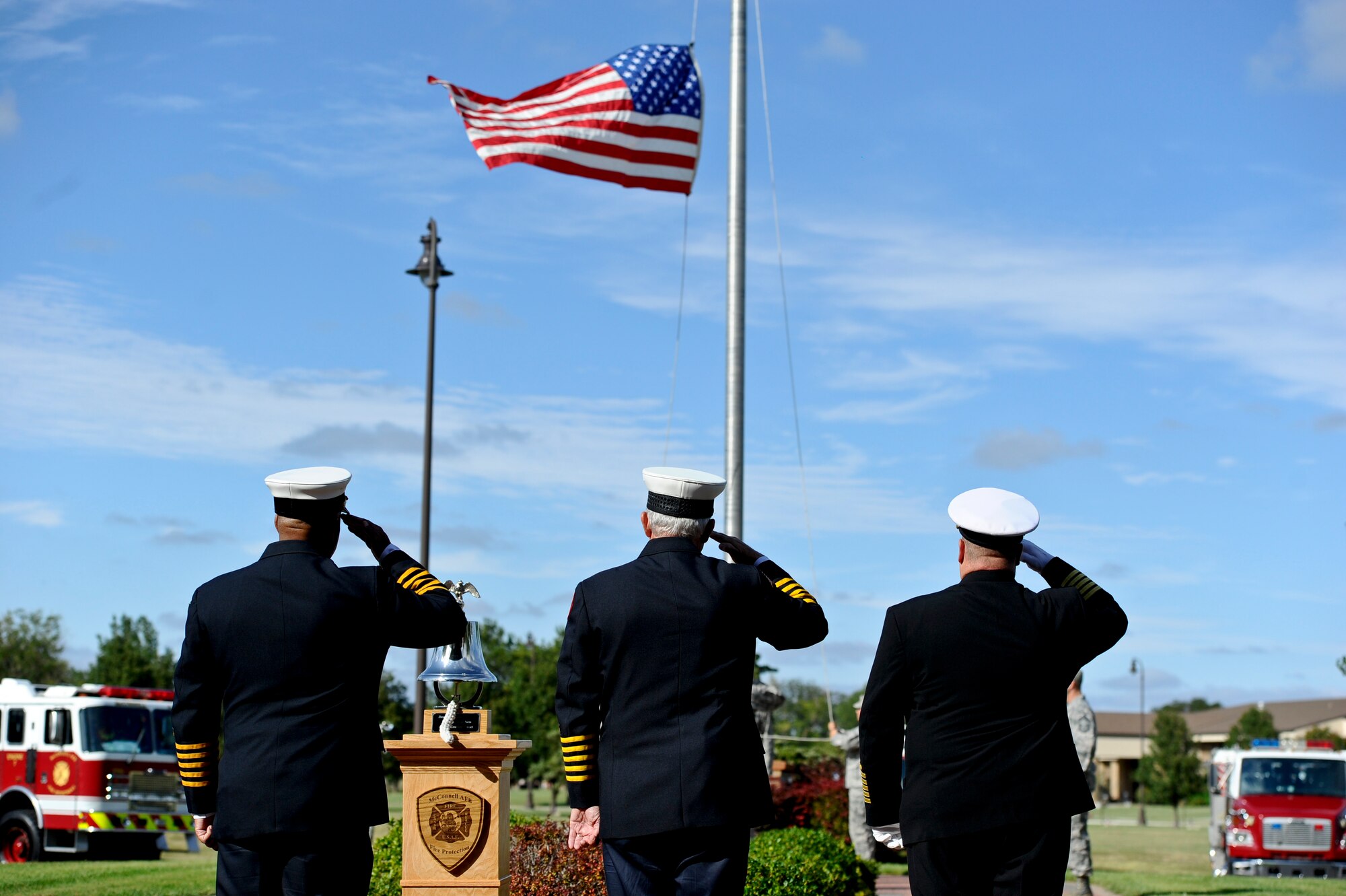 First responders salute the American flag during a Patriot Day ceremony Sept. 11, 2014, at McConnell Air Force Base, Kan. The ceremony was held in honor of the nearly 3,000 people who died during the 9/11 attacks. (U.S. Air Force photo/Airman 1st Class John Linzmeier)