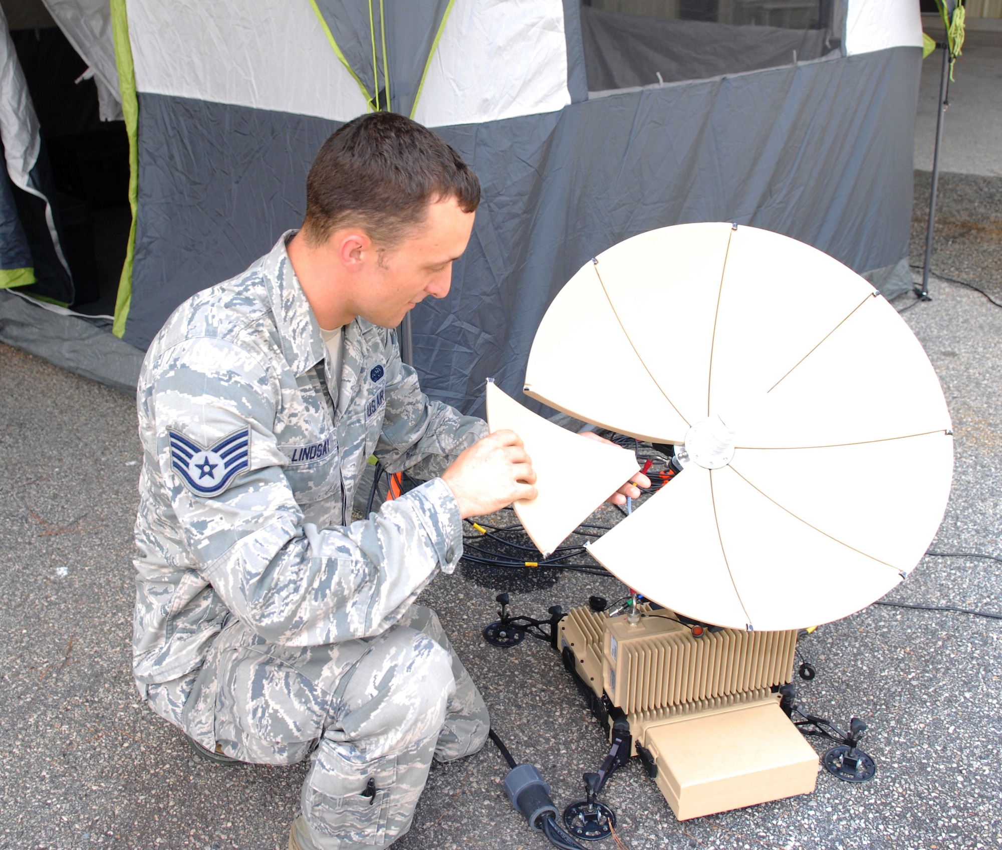 Staff Sgt. Michael Lindsay, Hammer ACE operator, pieces together a satellite terminal used for emergency response missions. A Hammer ACE team was deployed from Robins following the recent F-15C accident in Virginia and remains at the site. (U.S. Air Force photo by Misuzu Allen)