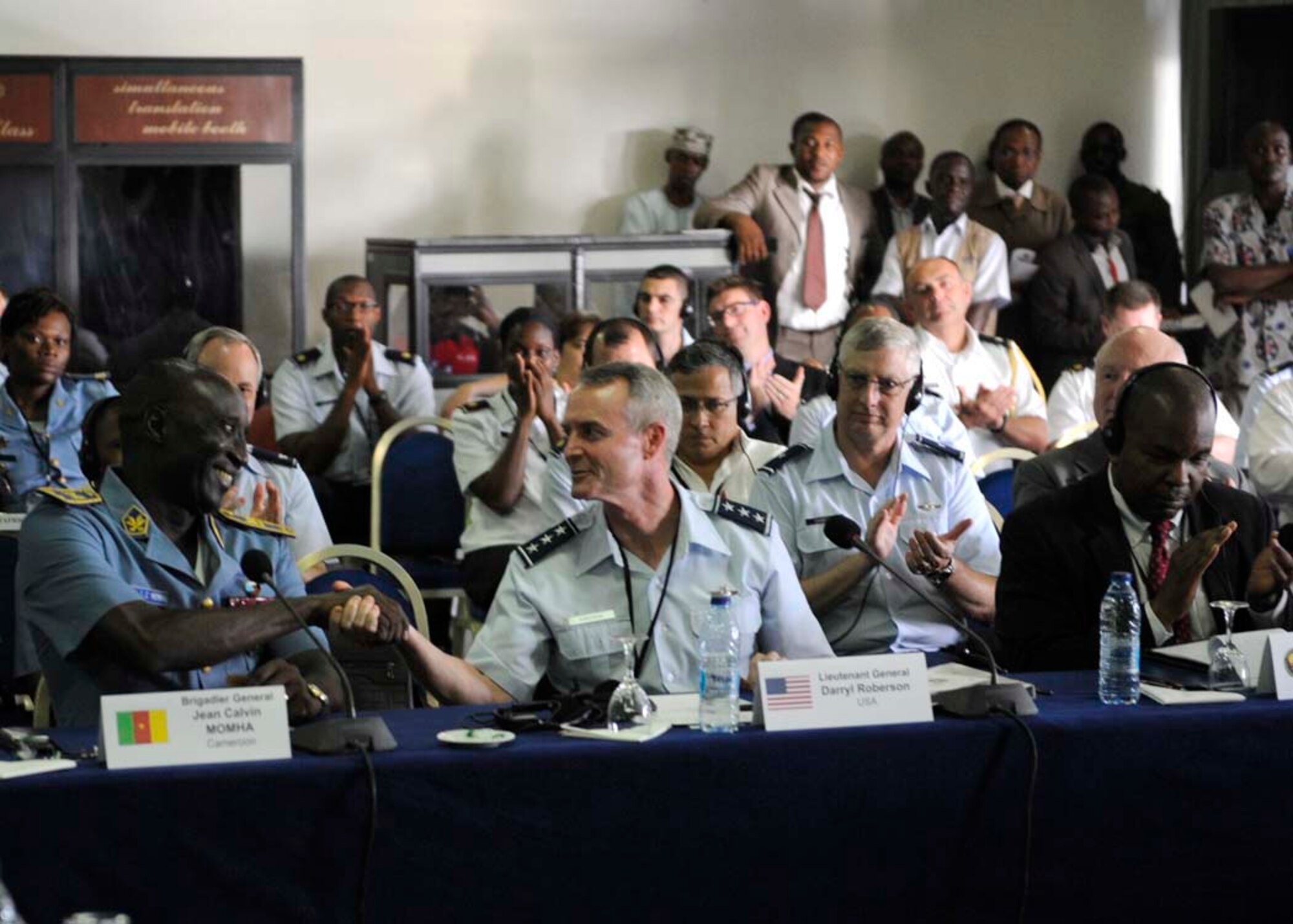 Lt. Gen. Darryl Roberson, 3rd Air Force commander, thanks Cameroon Air Force Brig. Gen. Jean Calvin Momha,Chief of Air Staff, for the outstanding Cameroonian reception and hosting of the symposium during 4th annual African Air Chiefs Symposium, Sept. 11, 2014, in Douala, Cameroon. He went on to say that it has been an honor and a privilege for us to be a part of this event. (U.S. Air Force photo by Tech. Sgt. Patrick Mitchell)