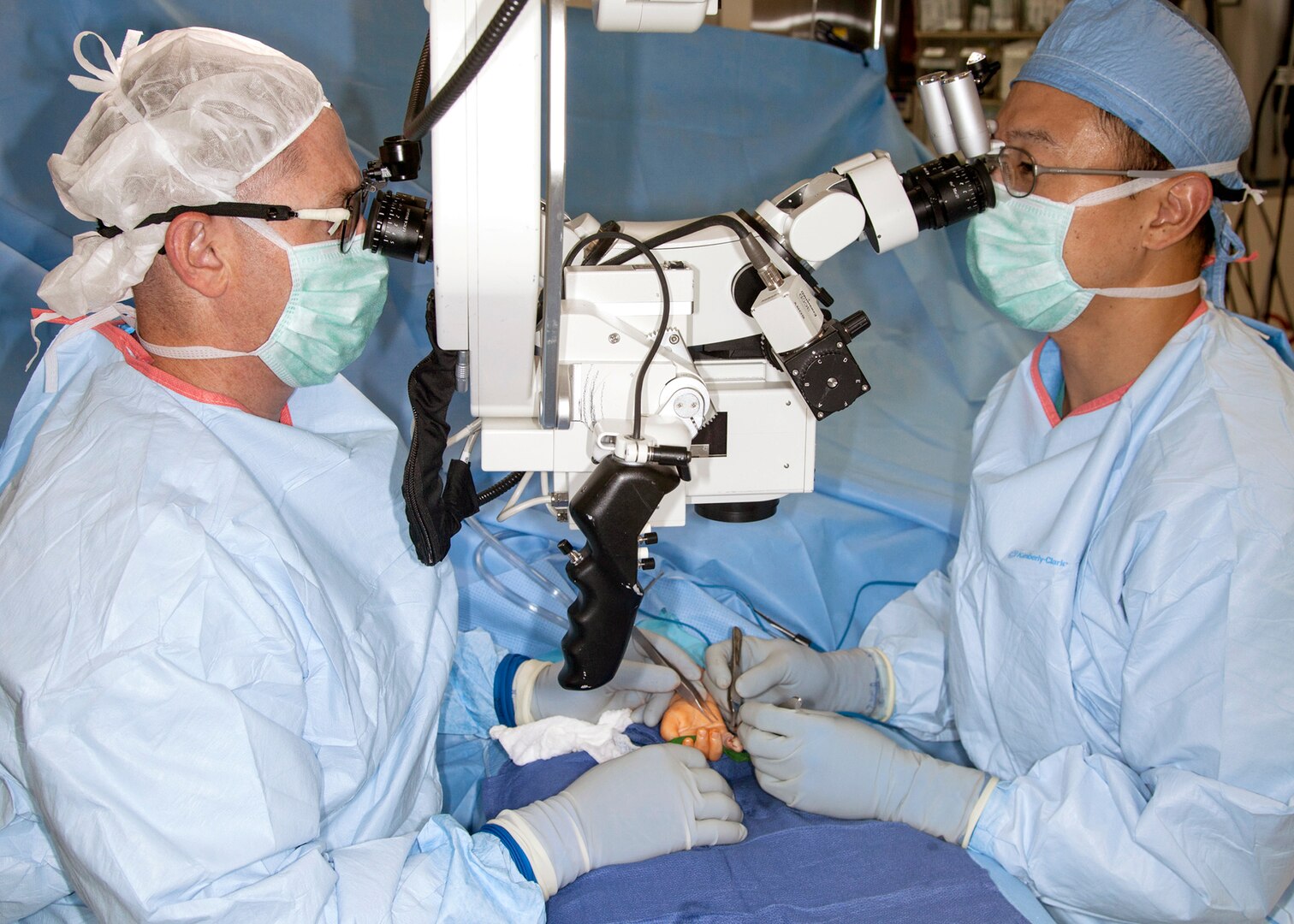 Air Force Lt. Col. (Dr.) Joseph Gower (left) and Air Force Maj. (Dr.) Peter Rhee perform microvascular surgery on a patient at Brooke Army Medical Center in August 2014. Earlier this year, Gower and Rhee launched a microvascular surgery on-call program at BAMC to better serve military and civilian trauma patients throughout the region.

Photo by Dwayne Snader