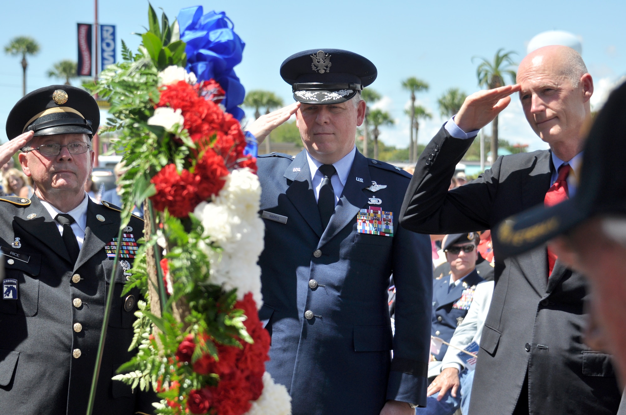 Brig. Gen. David Harris, 96th Test Wing commander pays respect to veterans and first responders with Army 1st Sgt. Tom Rice (ret.) and Florida Gov. Rick Scott at a Dedication Ceremony of the Freedom Bell in Fort Walton Beach, Fla. Casting the bell was the first step in building the Veterans Tribute Tower at Beal Memorial Cemetery, a community project to show appreciation for veterans from all military services and conflicts. In particular, the ceremony remembered and honored those who were lost on 9/11. (U.S. Air Force photo/Ilka Cole)