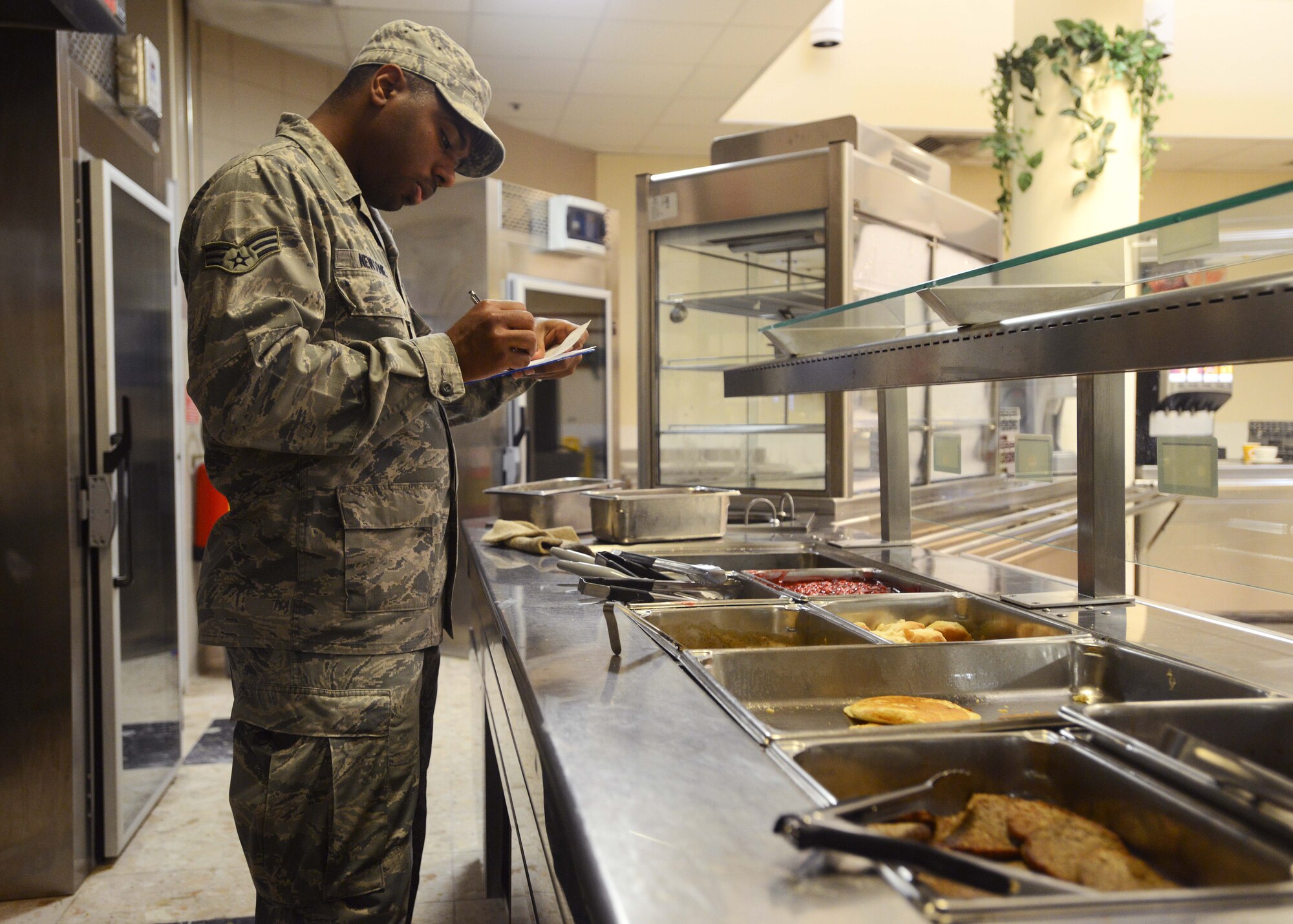 Senior Airman Christopher Newsome, 31st Force Support Squadron food services journeyman, documents leftover food items, Sept. 8, 2014, at Aviano Air Base, Italy. As a food services journeyman, Newsome is in charge of cooking and inspecting food according to Air Force standards. (U.S. Air Force photo/Airman 1st Class Deana Heitzman)