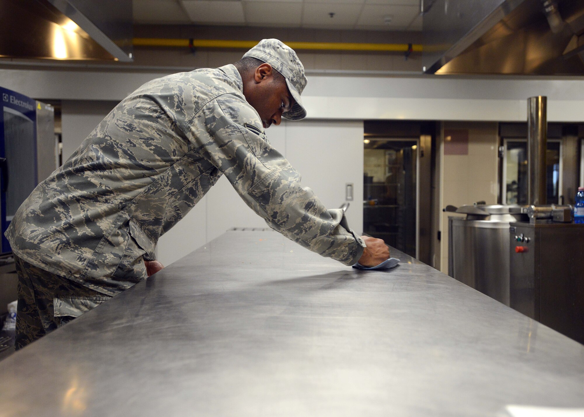 Senior Airman Christopher Newsome, 31st Force Support Squadron food services journeyman, cleans a counter after cooking, Sept. 8, 2014, at Aviano Air Base, Italy. Being a part of the 31st FSS, service members have the opportunity to work at lodging, the fitness center, food services and in readiness.  (U.S. Air Force photo/Airman 1st Class Deana Heitzman)