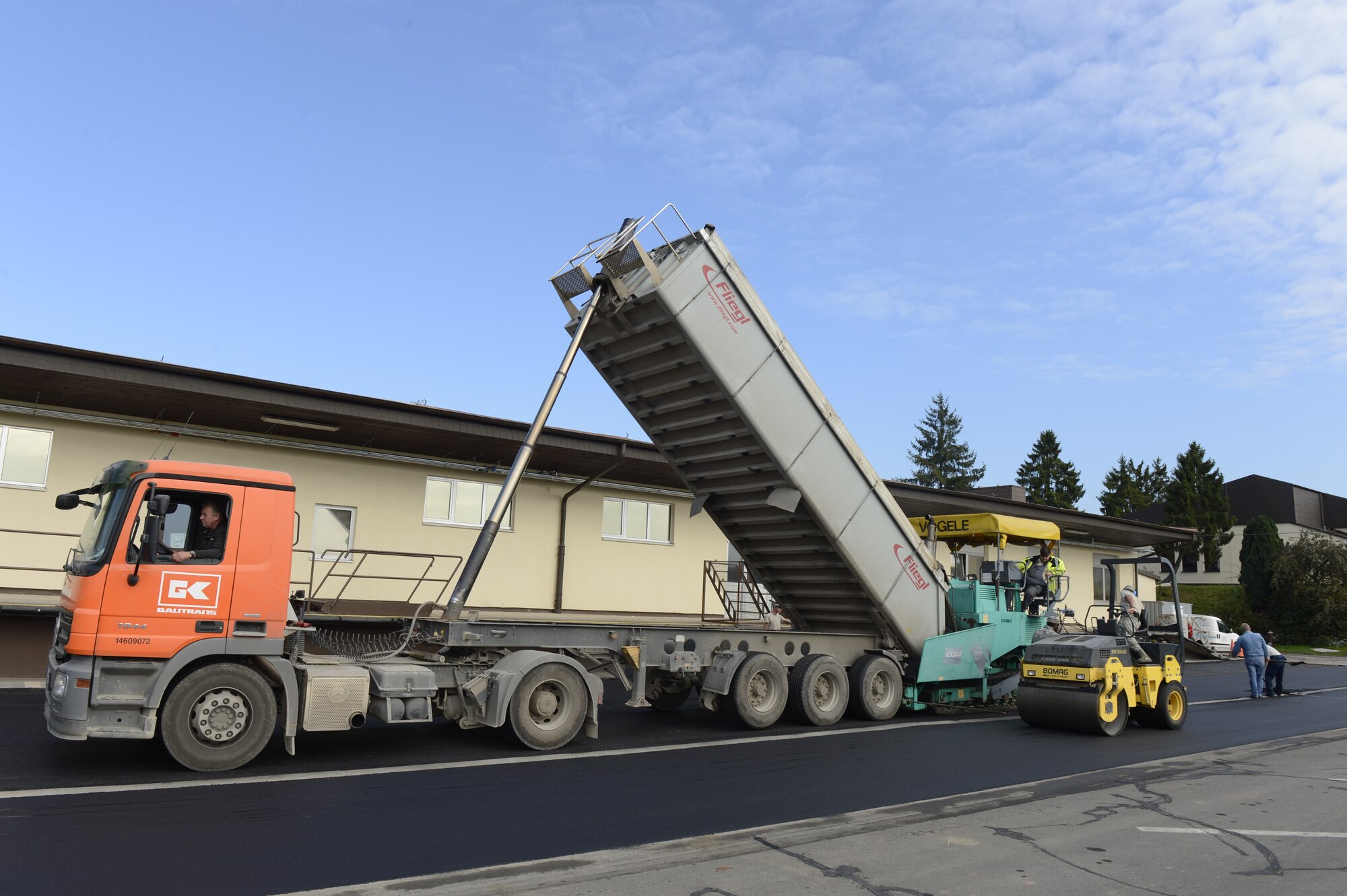 Airmen from the 52nd Civil Engineer Squadron, with help from the 435th Construction Training Squadron, Ramstein Air Base, work to replace the asphalt behind the 52nd Logistics Readiness Squadron at Spangdahlem Air Base, Germany, Sept. 12, 2014. The road was replaced due to cracks in the asphalt. (U.S. Air Force photo by Staff Sgt. Christopher Ruano/Released)