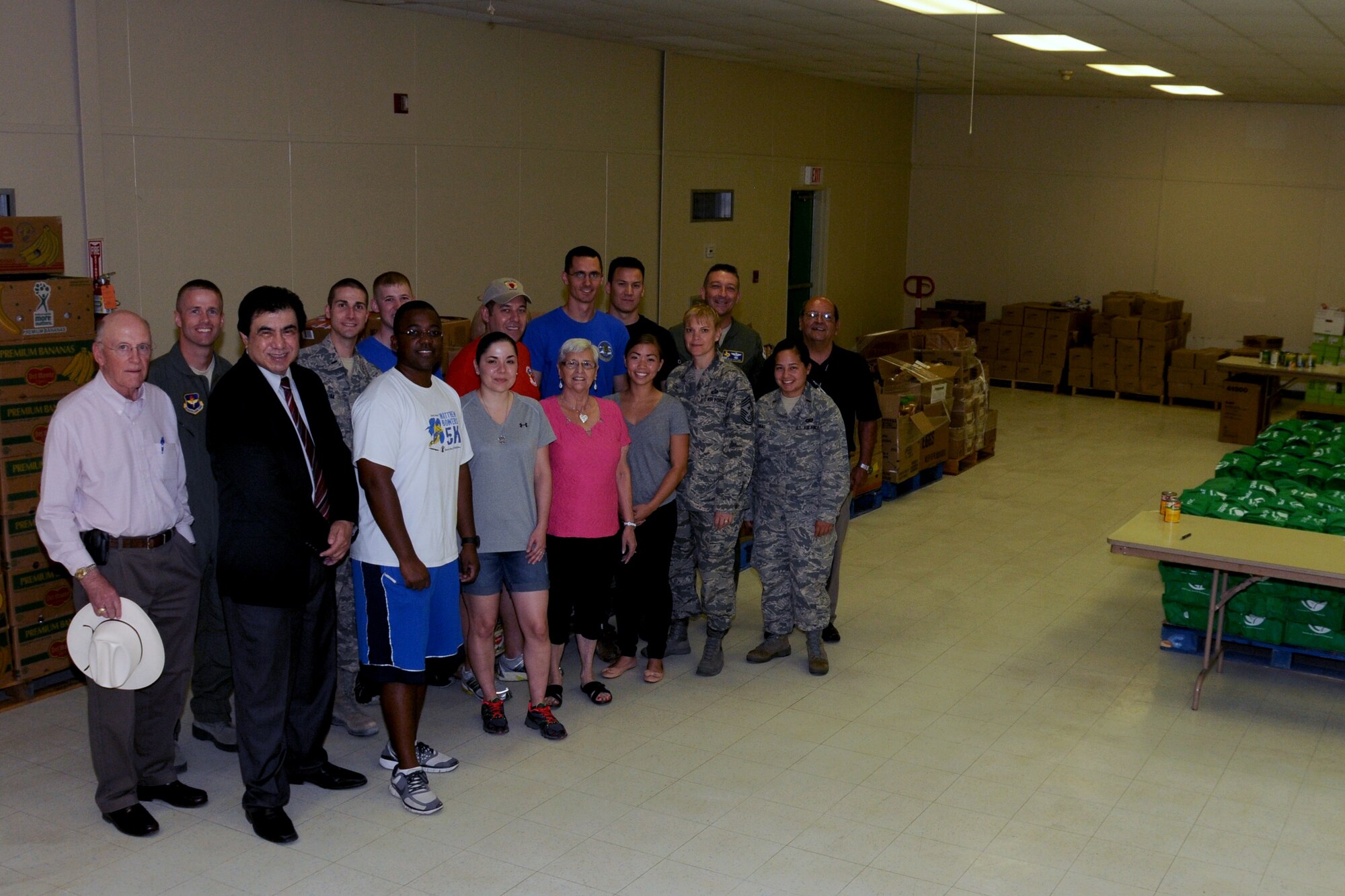Robert Garza, Del Rio mayor, foreground right, poses with members of Laughlin Air Force Base and Loaves and Fishes in Del Rio, Texas, Sept. 10, 2014. More than 10,400 pounds of food collected at Laughlin was delivered to Loaves and Fishes, a local food bank, as part of the Feds Feed Families campaign. The Feds Feed Families campaign was created by the Defense Commissary Agency to give commissary customers and government employees the opportunity to donate non-perishable items to the local community's food banks. (U.S. Air Force photo by Airman 1st Class Ariel D. Delgado)(Released)