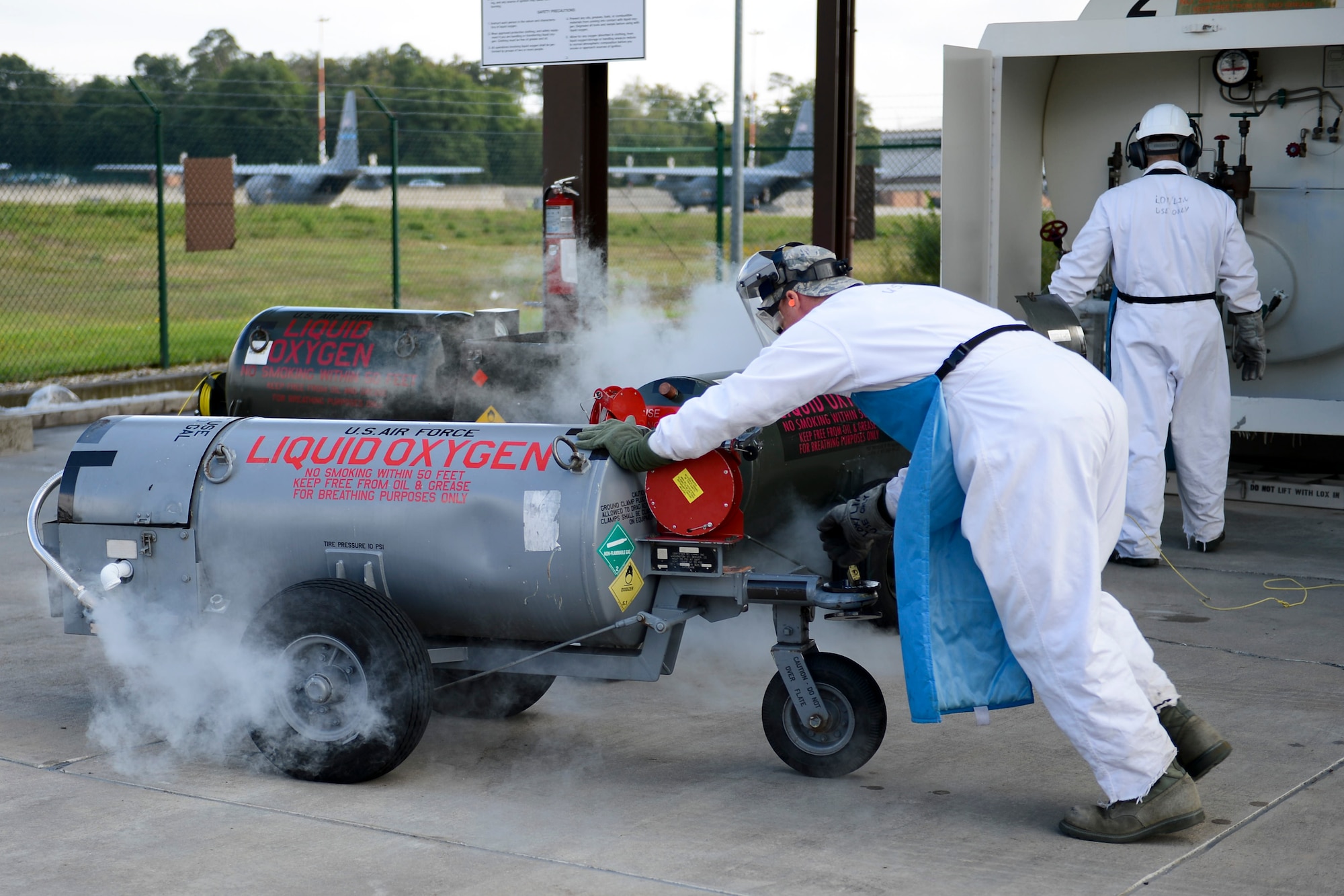 Senior Airman Seth Bruning, 86th Logistics Readiness Squadron hydrants technician, pushes a liquid oxygen tank on Ramstein Air Base, Germany, Sept. 3, 2014. The 50-gallon, liquid oxygen tank is used as breathing oxygen for aircrew members during missions when brought to room temperature. (U.S. Air Force photo/Airman 1st Class Michael Stuart)