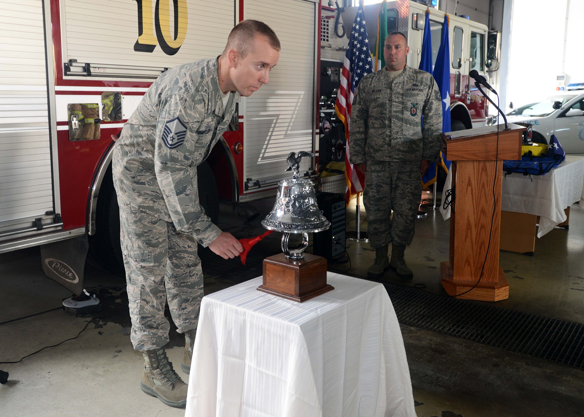 Master Sgt. Walter Shutler, 31st Civil Engineer Squadron assistant chief of operations, rings the last alarm during a 9/11 remembrance ceremony, Sept. 11, 2014, at Aviano Air Base, Italy. The last alarm was sounded to remember the firefighters who paid the ultimate sacrifice during the line of duty. (U.S. Air Force photo/Airman 1st Class Deana Heitzman)